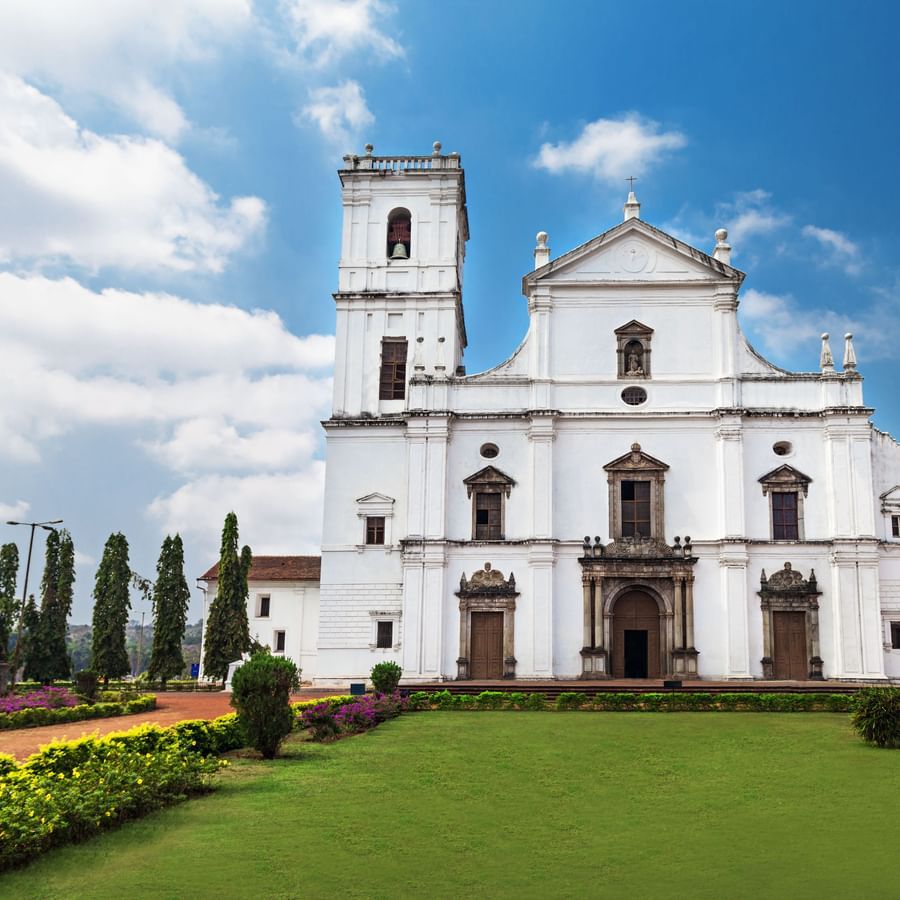 facade view of Se Cathedral Church during daytime with a garden in front of it