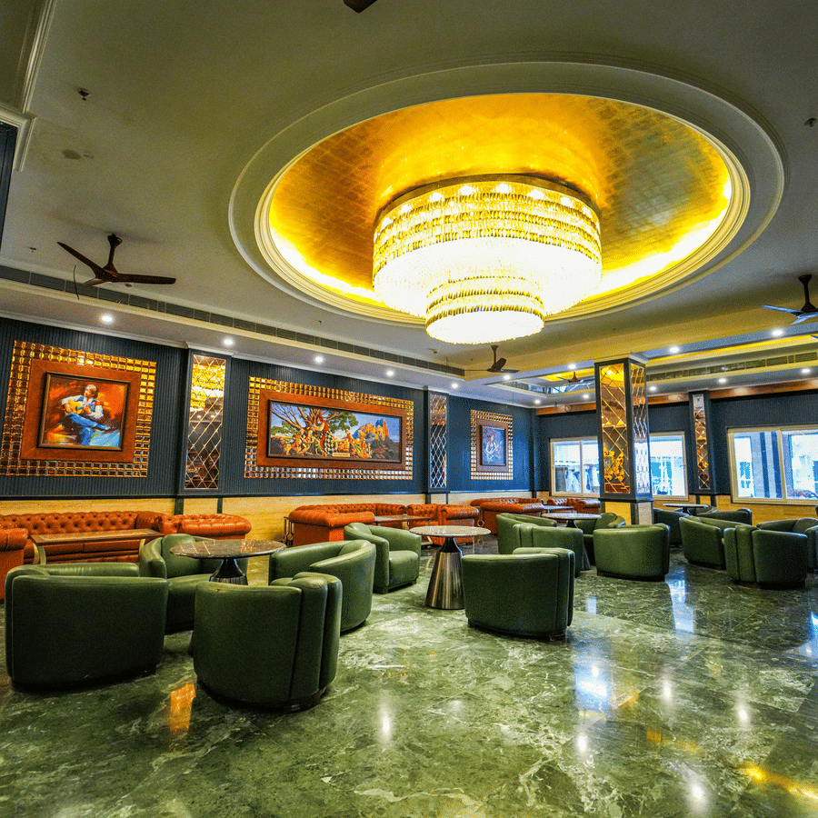 Grand lobby lounge with ornate ceiling and marble flooring at MAYFAIR Oasis Resort and Convention Jharsuguda