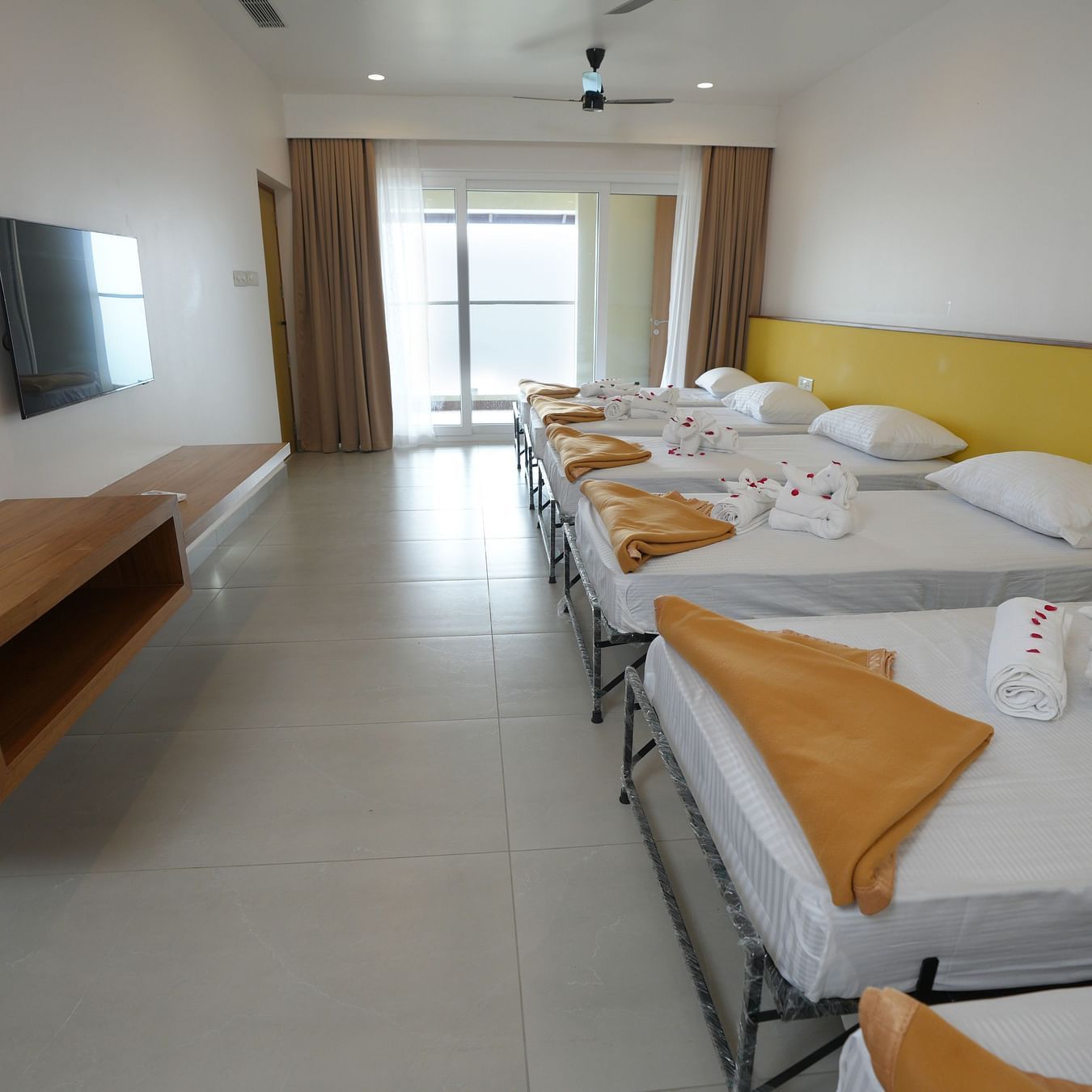 Multiple single beds placed in a row in a room  | Misty Queen by Dimora, Kakkadampoyil