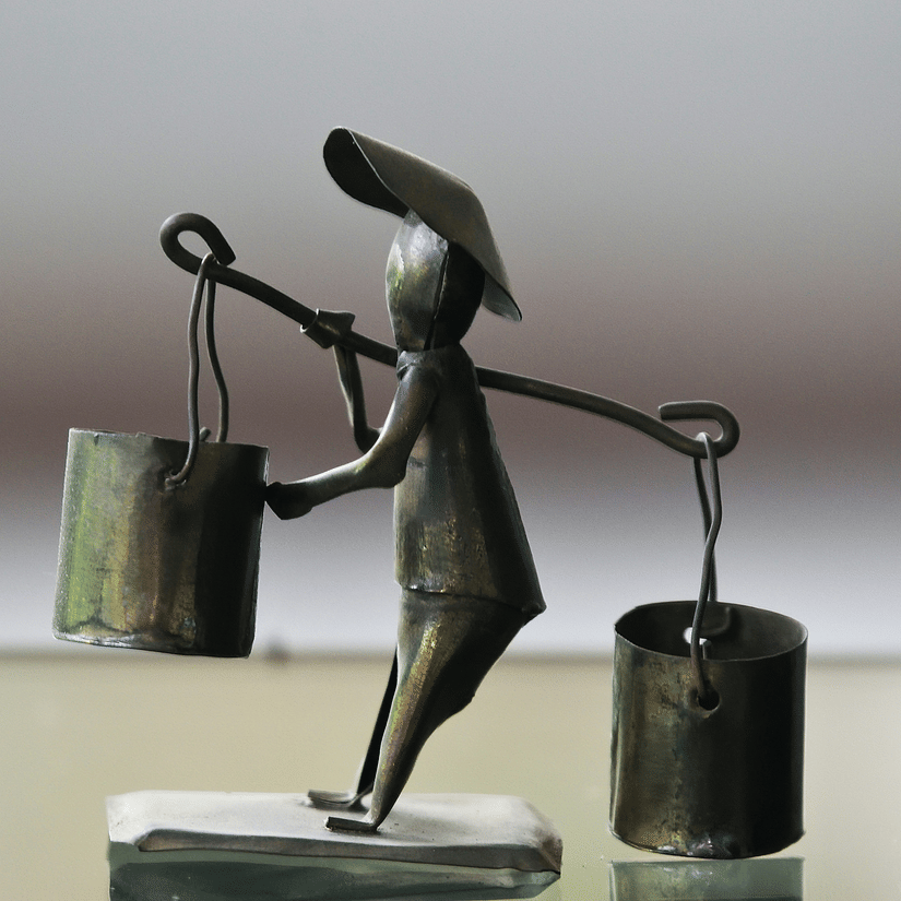 Handcrafted Dokra metal figurine representing traditional folk art.