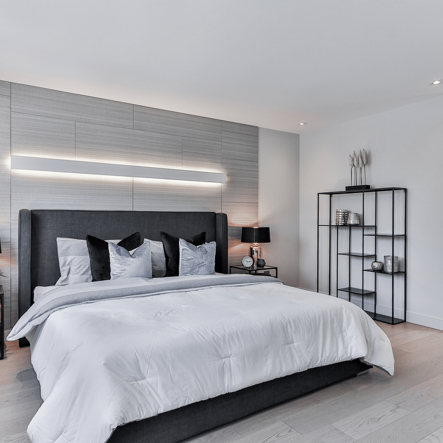 a room image with a neatly arranged bed and well lit lighting and modern ambience