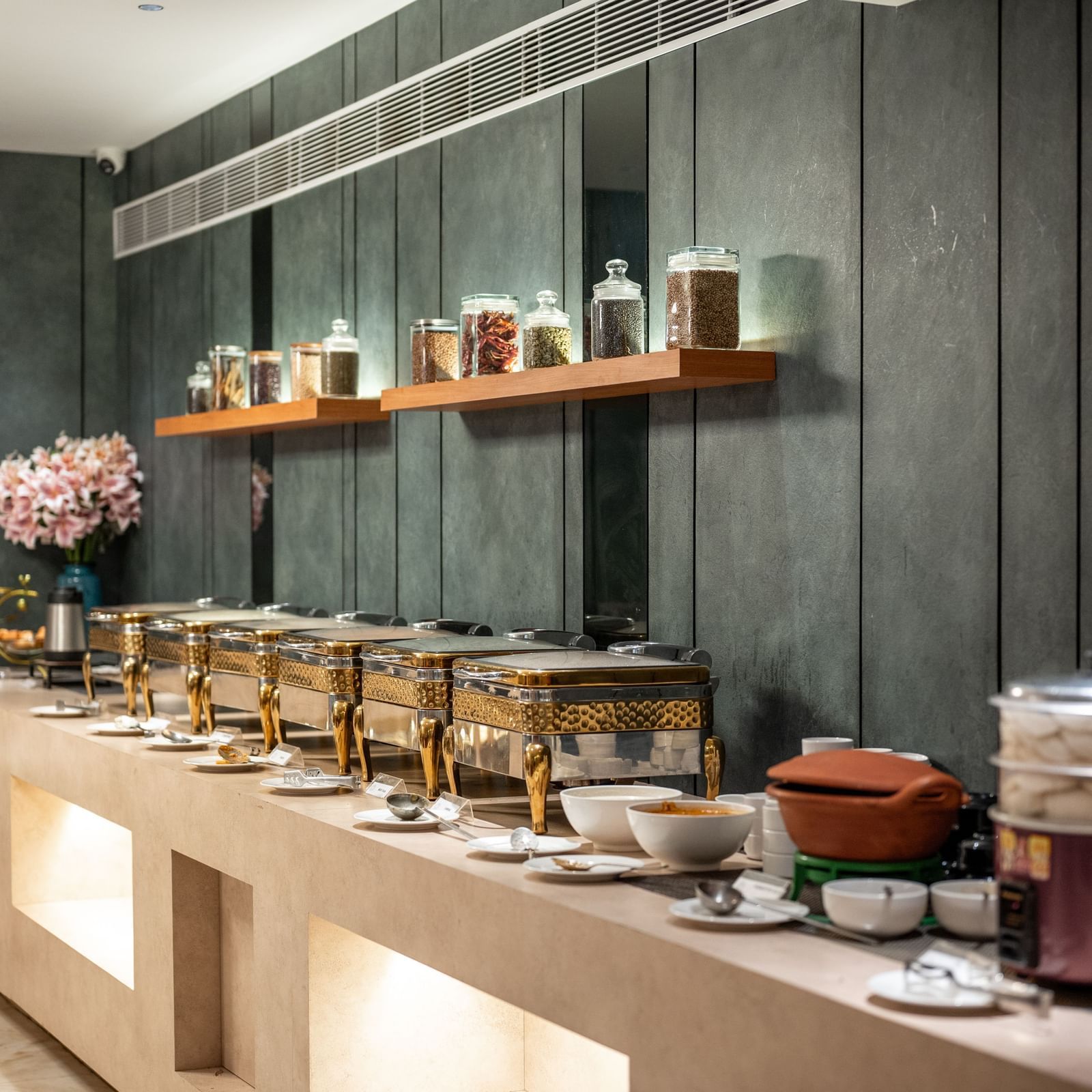 Buffet spread with assorted jars and traditional pots at Hotel Royal Regency Chennai