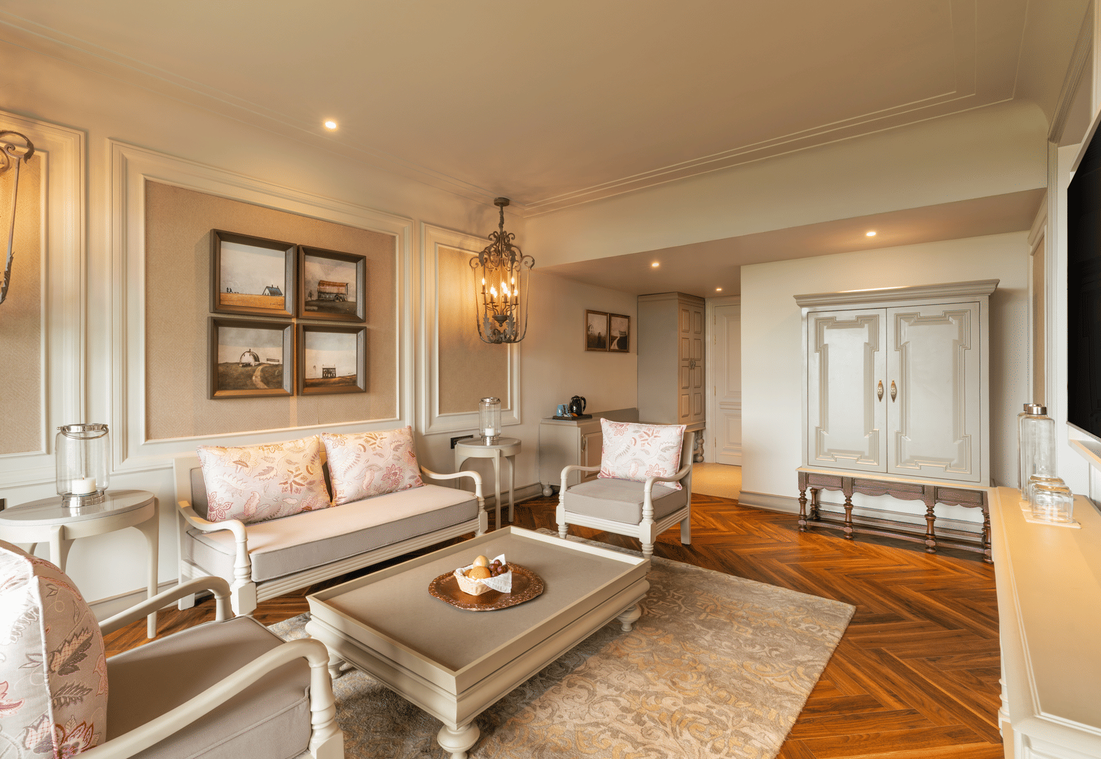 A wide-angle shot of the spacious living room at the Evren Suite featuring a beautiful couch set along with a coffee table in front of it at The Evren, Vagator.