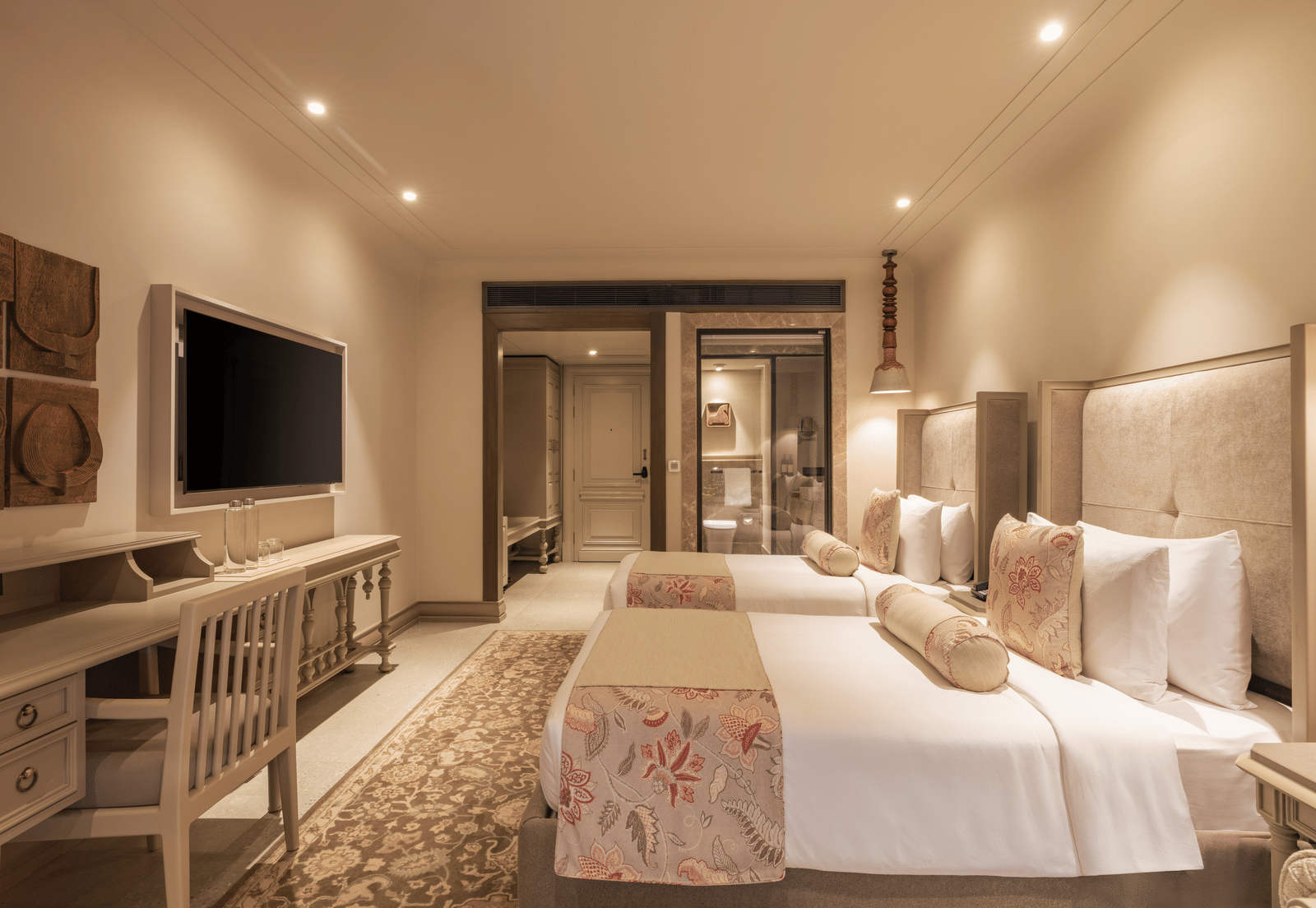 Side-view shot of the Premium Room featuring a twin bed with bright interiors at The Evren, Vagator.