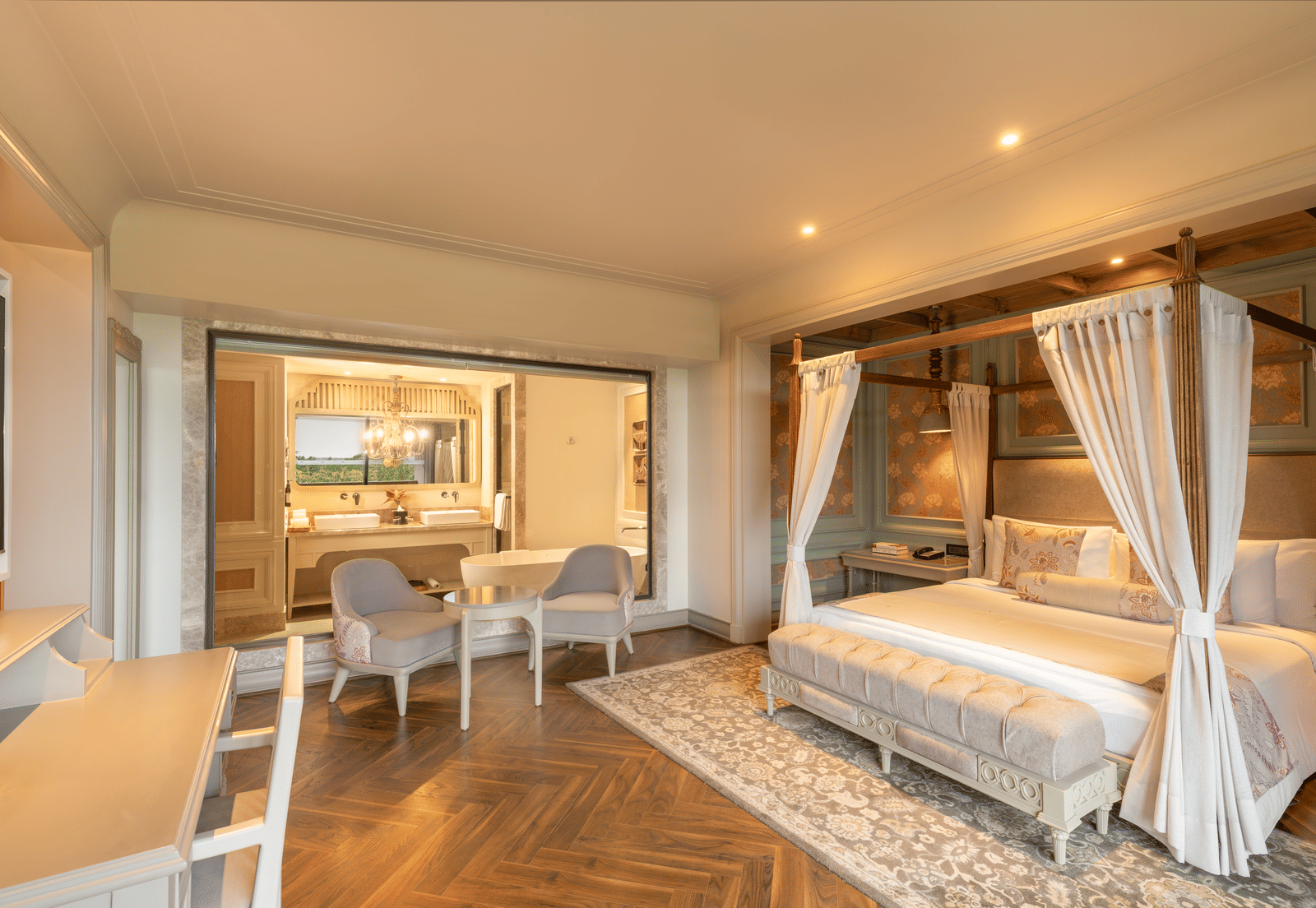 Side-view of the bedroom at the Evren Suite featuring a double bed along with a huge glass partition separating the bedroom with the bathroom at The Evren, Vagator.