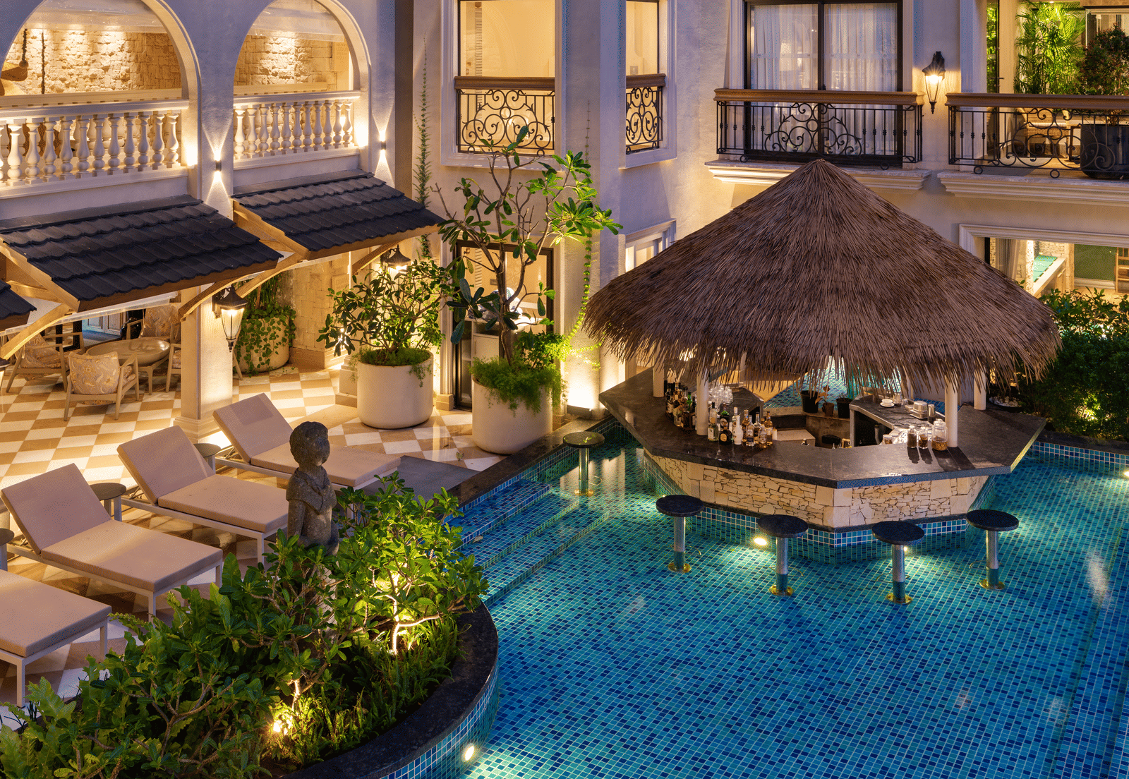 Close-up shot of the Splash Pool Bar featuring a pool-side bar counter cover with thatched roof at The Evren, Vagator.