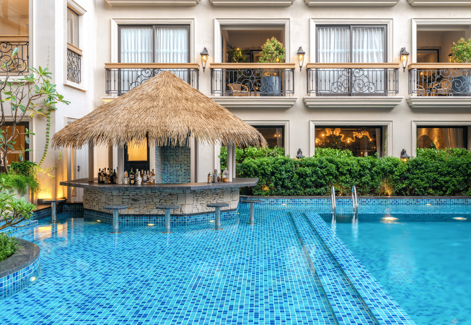 The Splash Pool Bar with calm waters in the swimming pool in the foreground at THe Evren, Vagator.