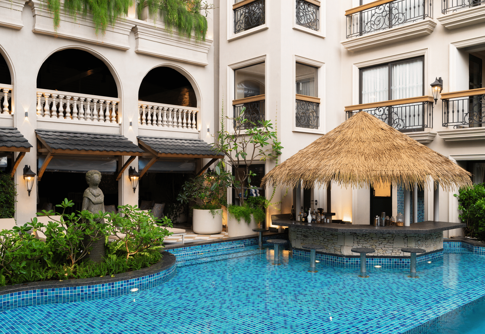 Side-view shot of the Splash Pool Bar with thatched roof above it at The Evren, Vagator.