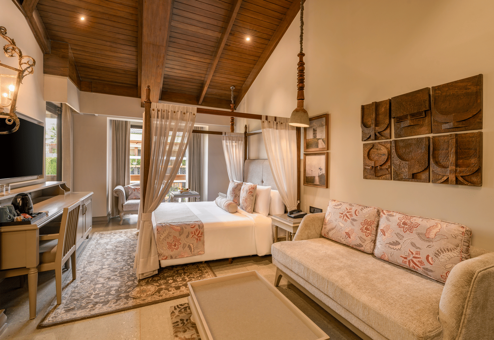 Full-view shot of the Executive Room featuring common seating area along with a double bed in the room at The Evren, Vagator.