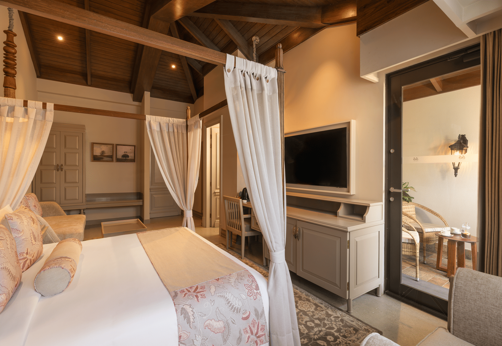 Side view of the Executive Room featuring a double bed with a television unit in front of it at The Evren, Vagator.