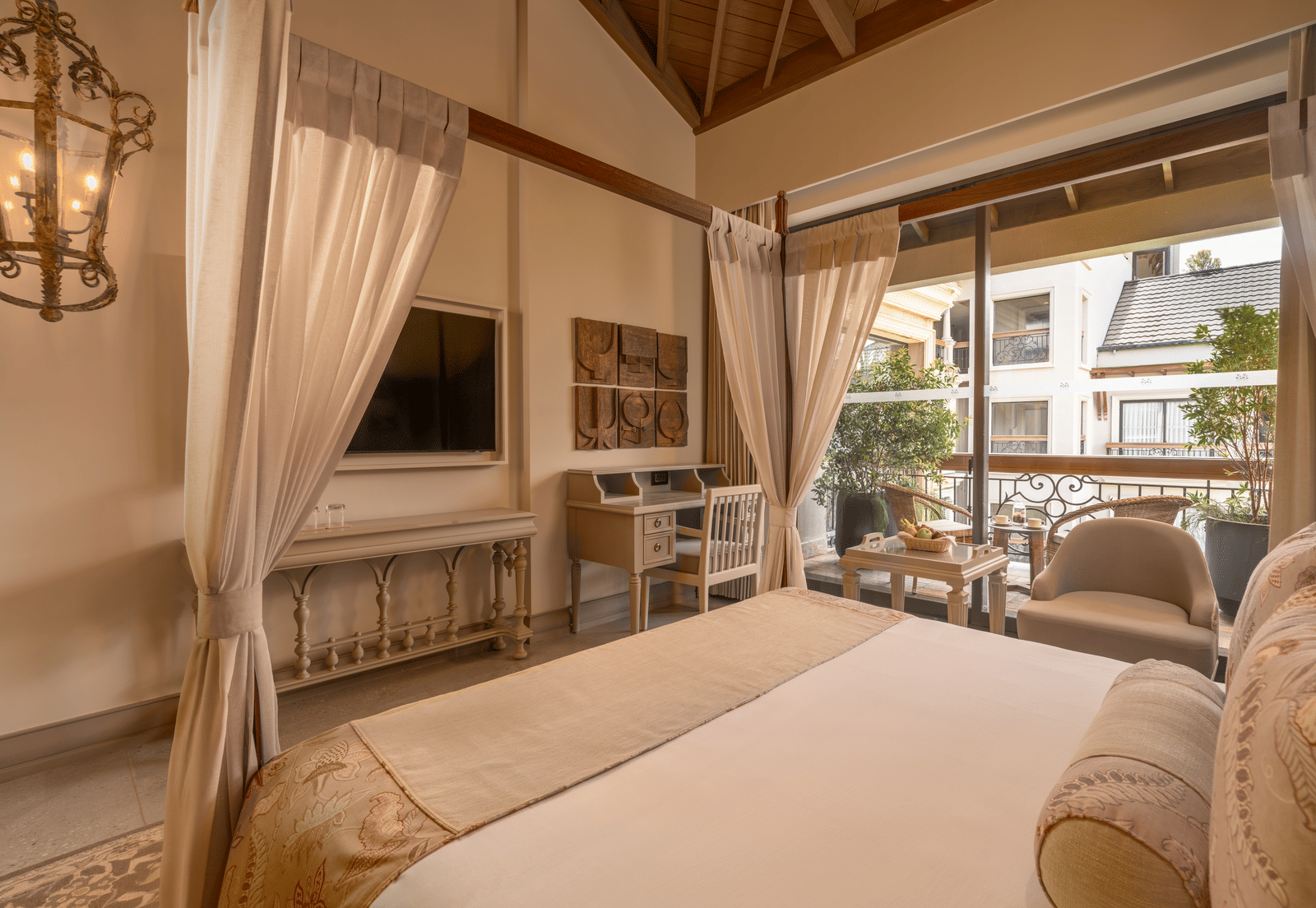 Corner view of the Premium Room featuring a double bed and wall-mounted television at The Evren, Vagator.