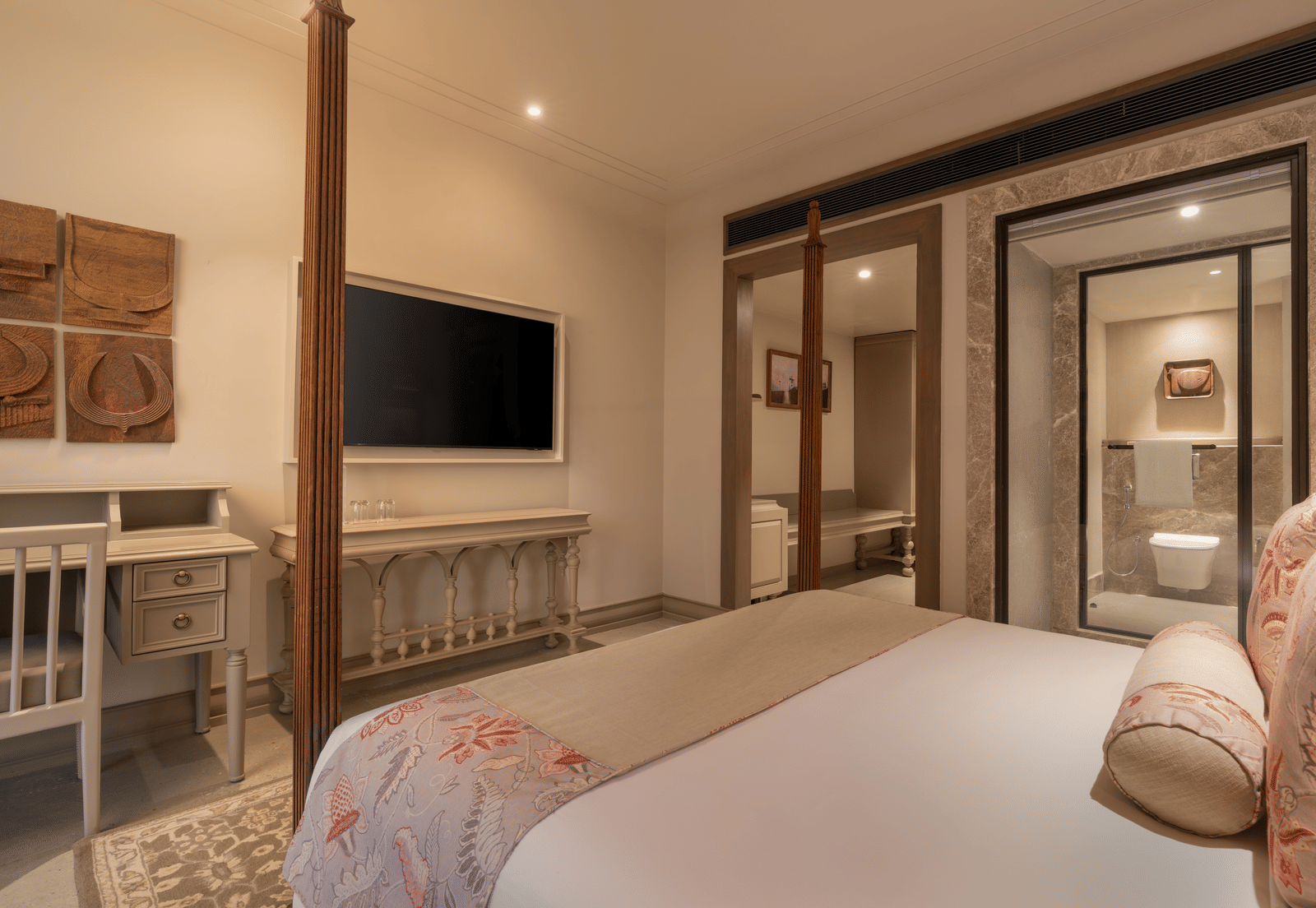 A corner view of the Claasic Room (Diwa) featuring a double bed along with a wall-mounted television in front of it at The Evren, Vagator.