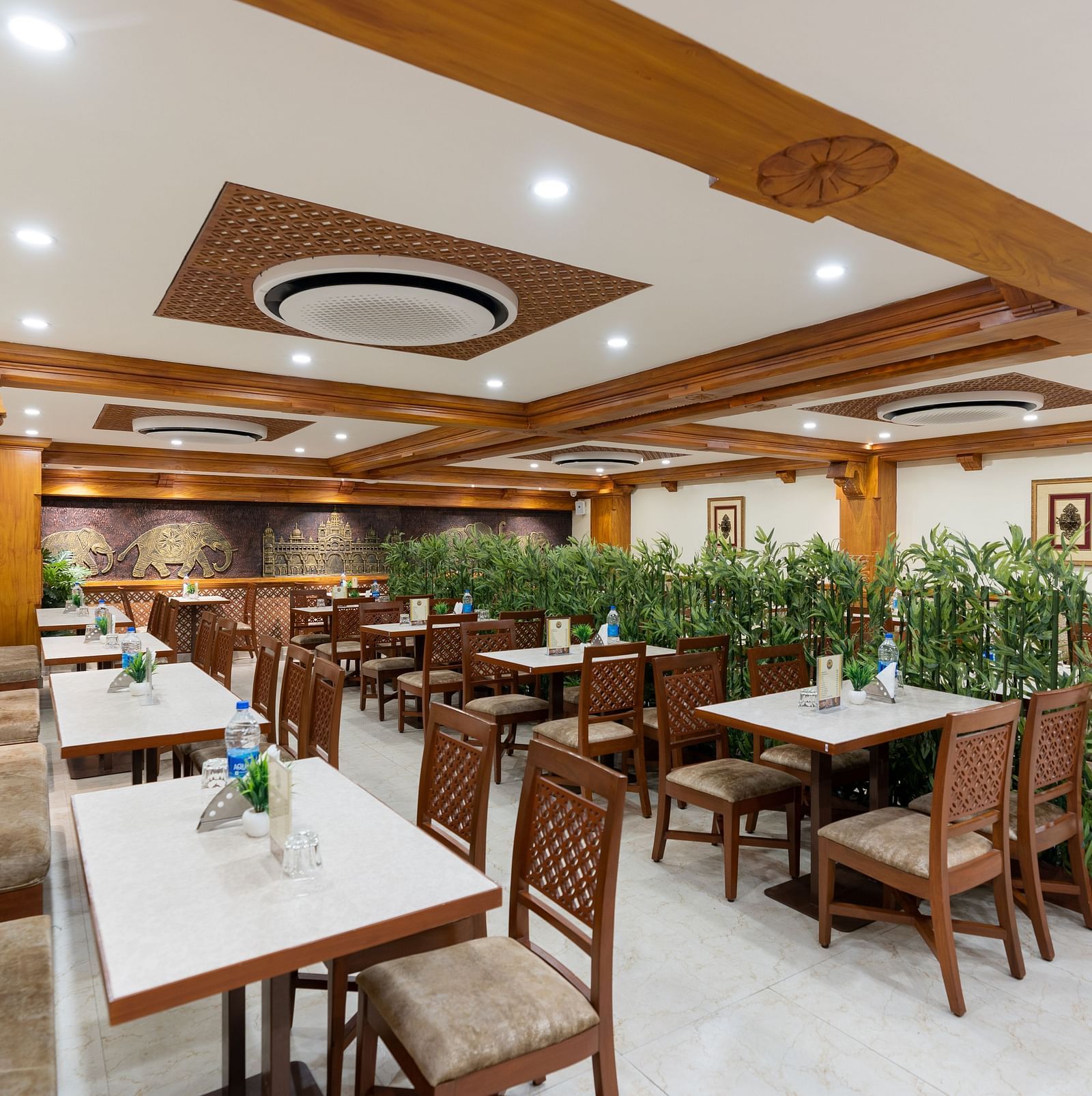 seating arrangements inside the restaurant area - Hotel Pai Vista, Mysore