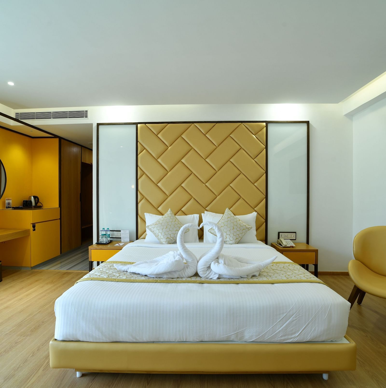 An image of bedroom with a tea & coffee maker and a portrait hanging on the wall -The President Hotel, Kumara Park, Bangalore