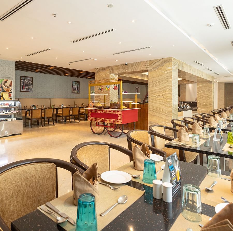 Side view of the restaurant with comfortable chair seating at Icon Premier Hotel by Bhagini, Devarabisanahalli