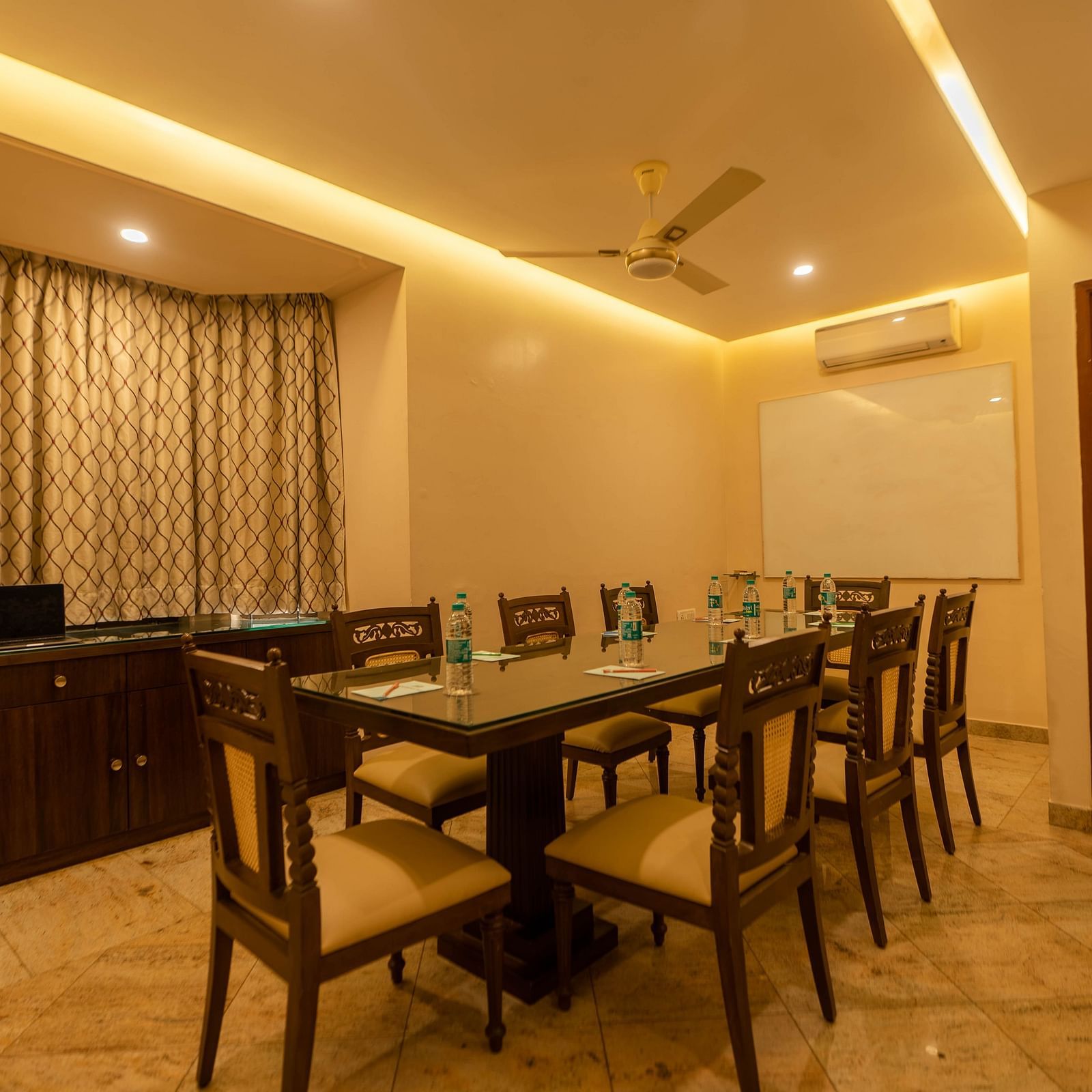 A meeting room at Hotel Pai Viceroy Jayanagar featuring seating for 8 persons, a white board and air-conditioning