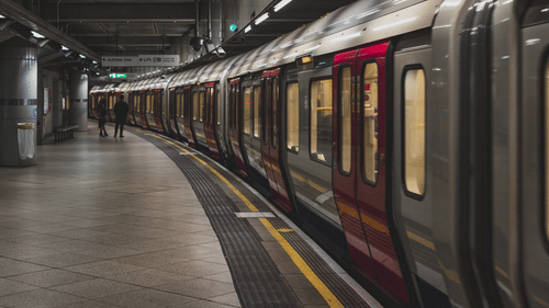 A train parked in a station with people in the background.