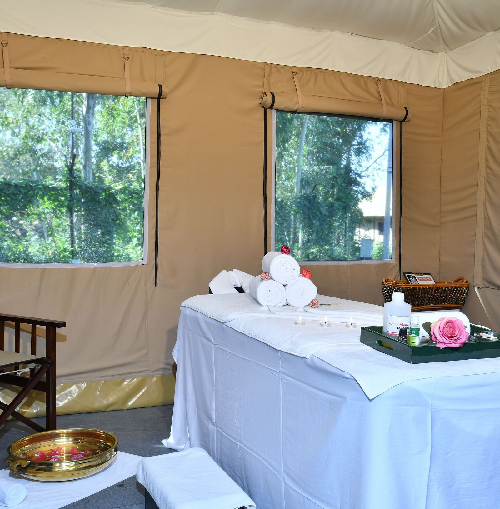 A spa with all the essentials with a window showcasing the greenery surrounding the spa - Aalia Jungle Resort & Spa