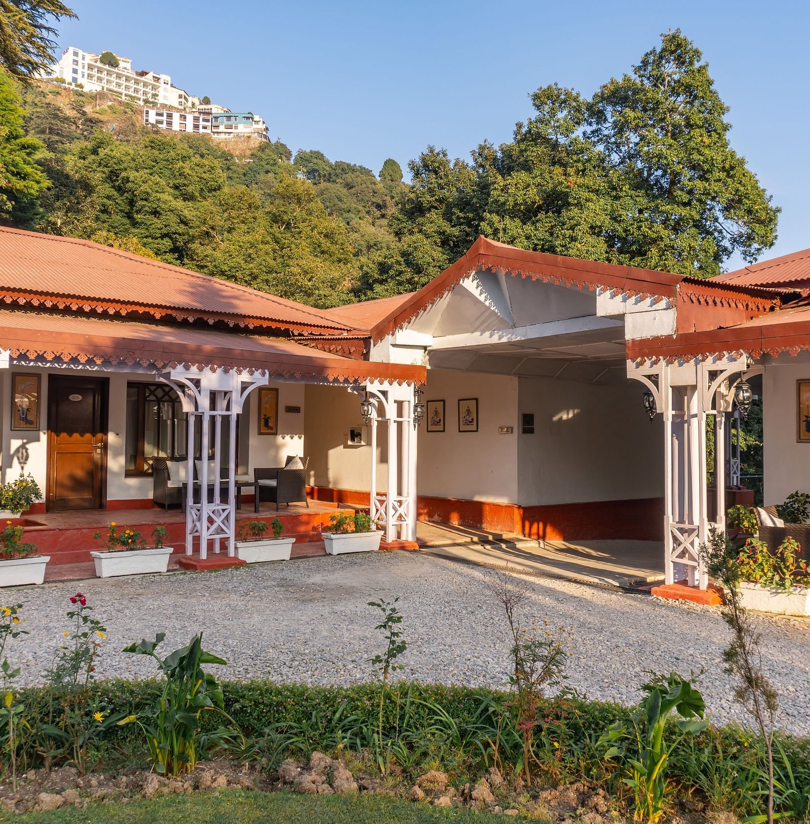 a facade image of our hotel in Mussoorie during a sunrise - The Claridges Nabha Residence