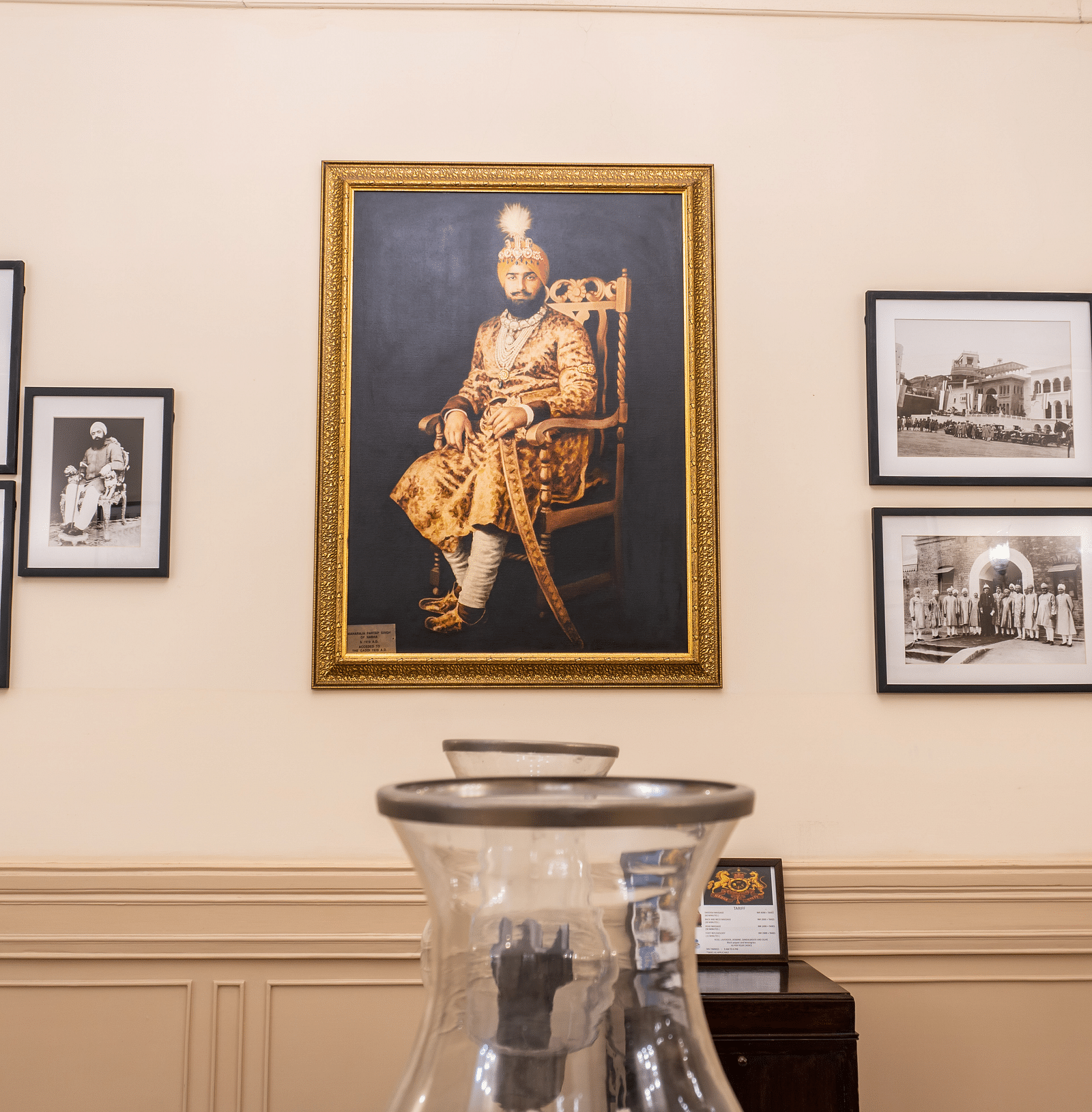 image of a photo wall with various black and white pictures along with a huge colour portrait at The Claridges Nabha Residence
