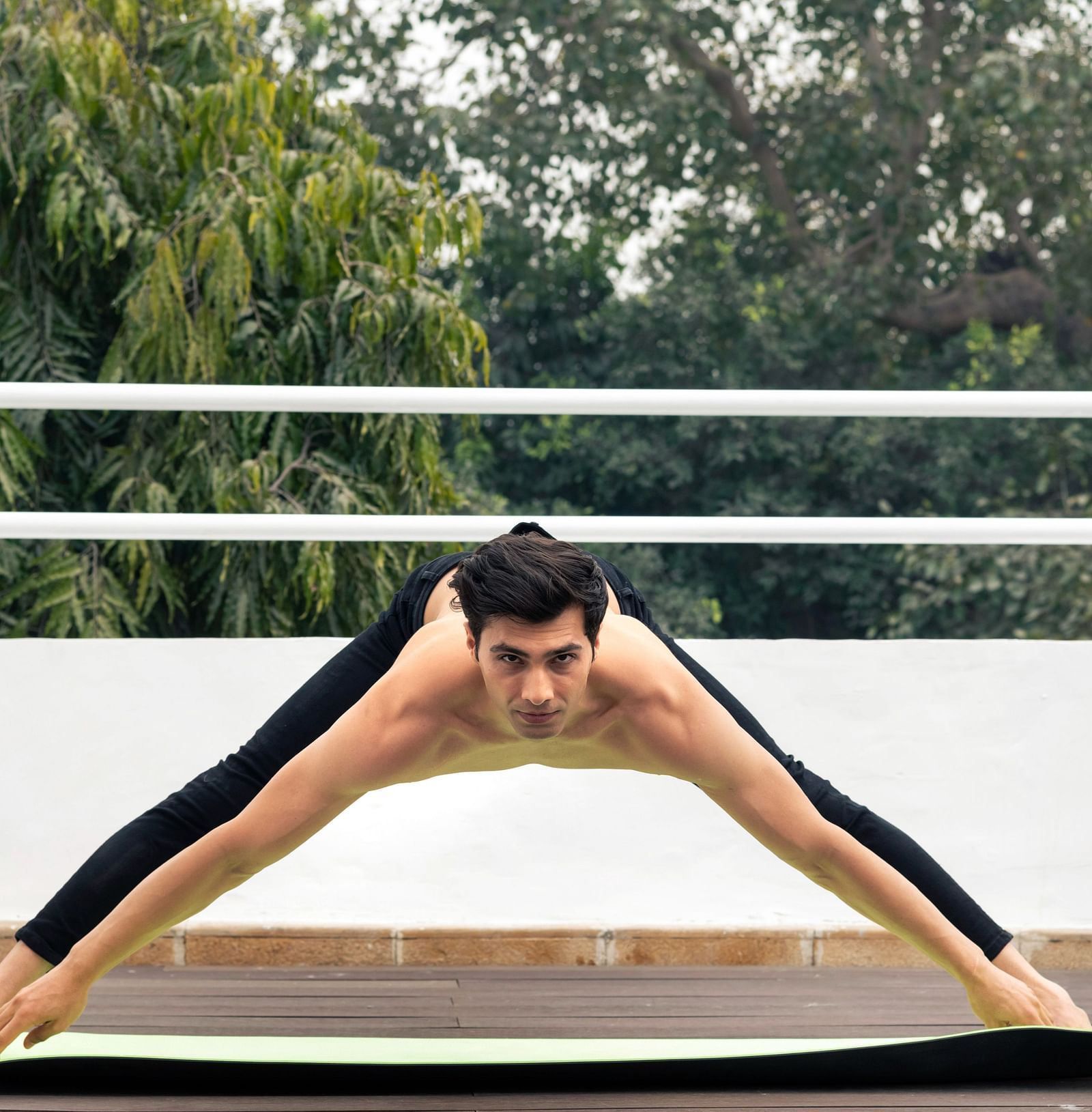 A person stretching into a challenging yoga posture
