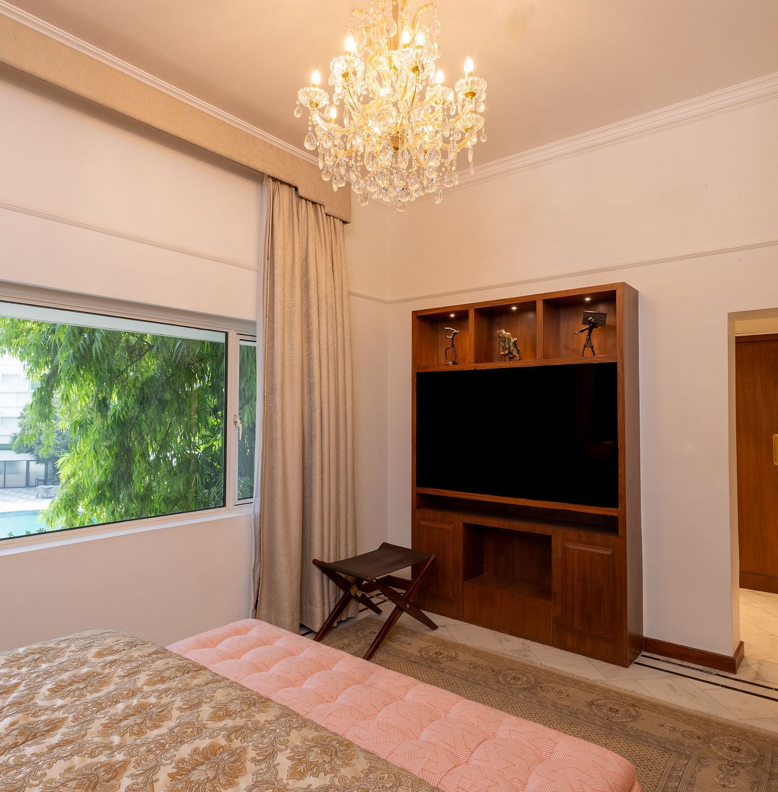 Luxury Suite at The Claridges New Delhi, showcasing an elegant chandelier hanging overhead