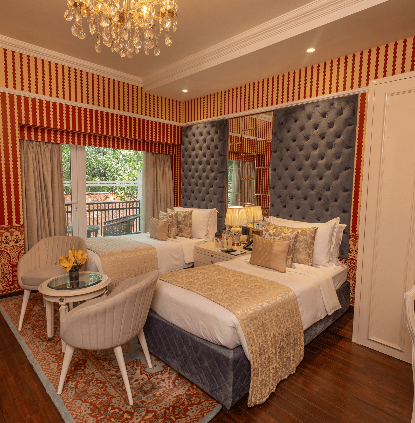 Luxury Twin Bed Room with Balcony at The Claridges New Delhi, featuring twin beds with pillows and a large window with a view