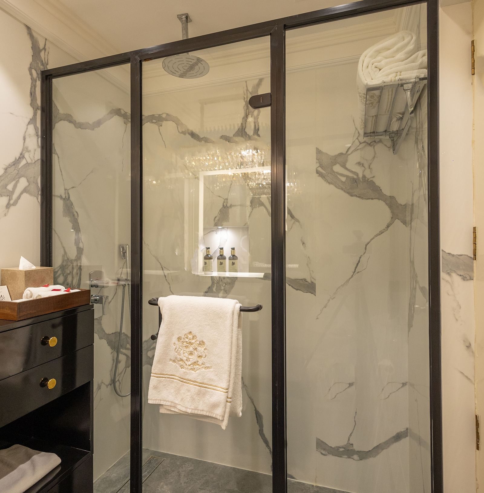 Superior King Bed Room washroom at The Claridges New Delhi, featuring a glass-enclosed bath area and a towel neatly hanging inside