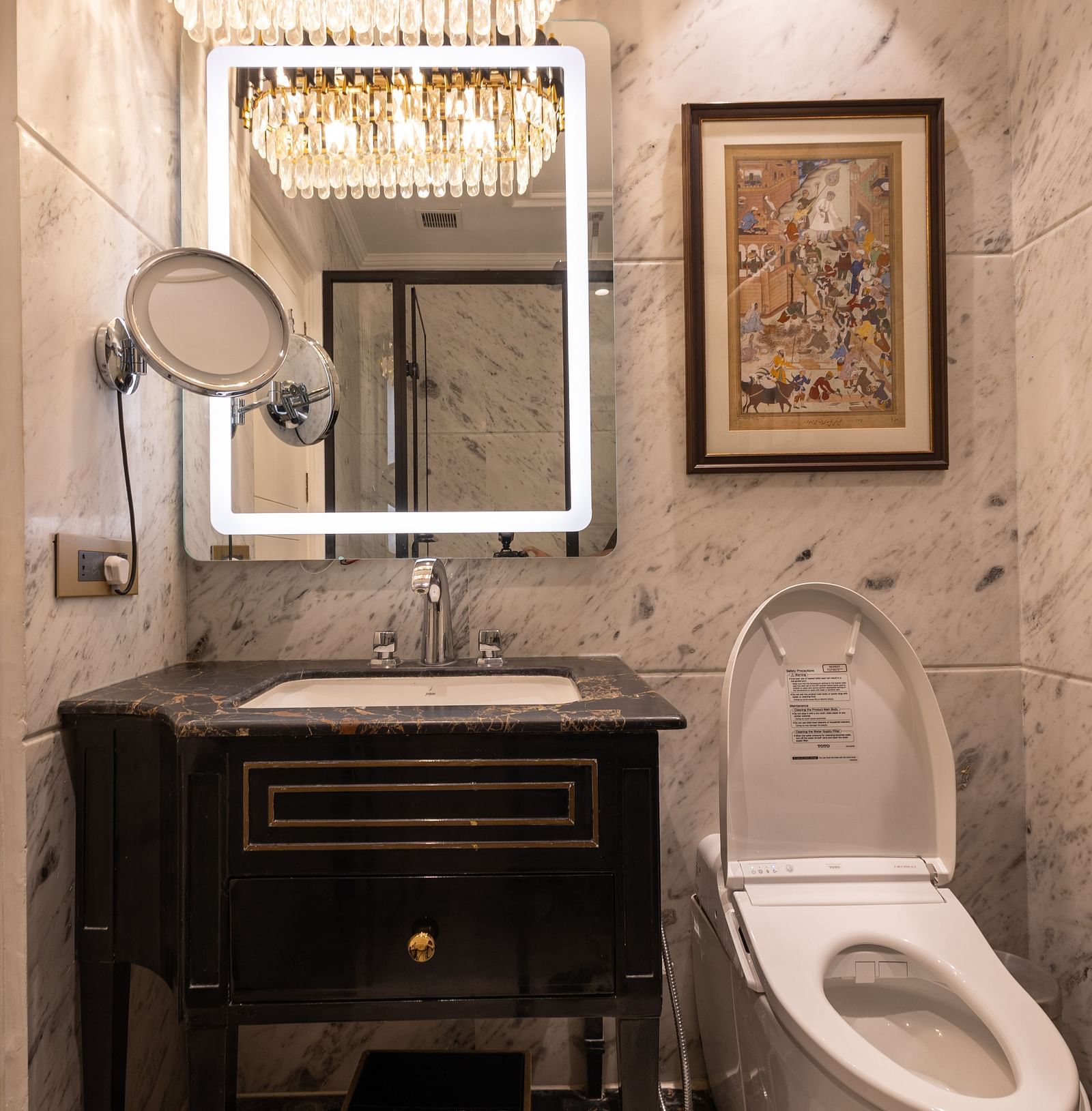 Washroom of the Luxury Twin Bed Room with Balcony at The Claridges New Delhi, featuring a modern sink and a stylish wall-mounted mirror