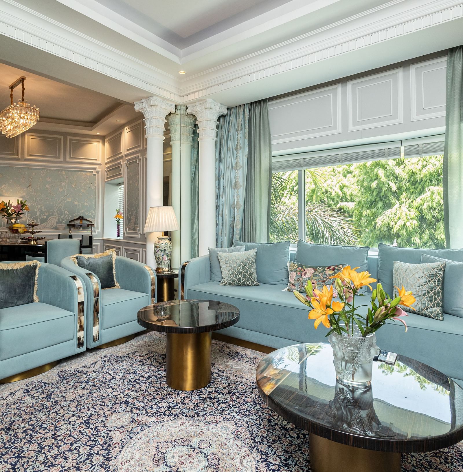 An image of the living area in our Diplomatic suite room with blue couches for comfort and elegance - The Claridges New Delhi