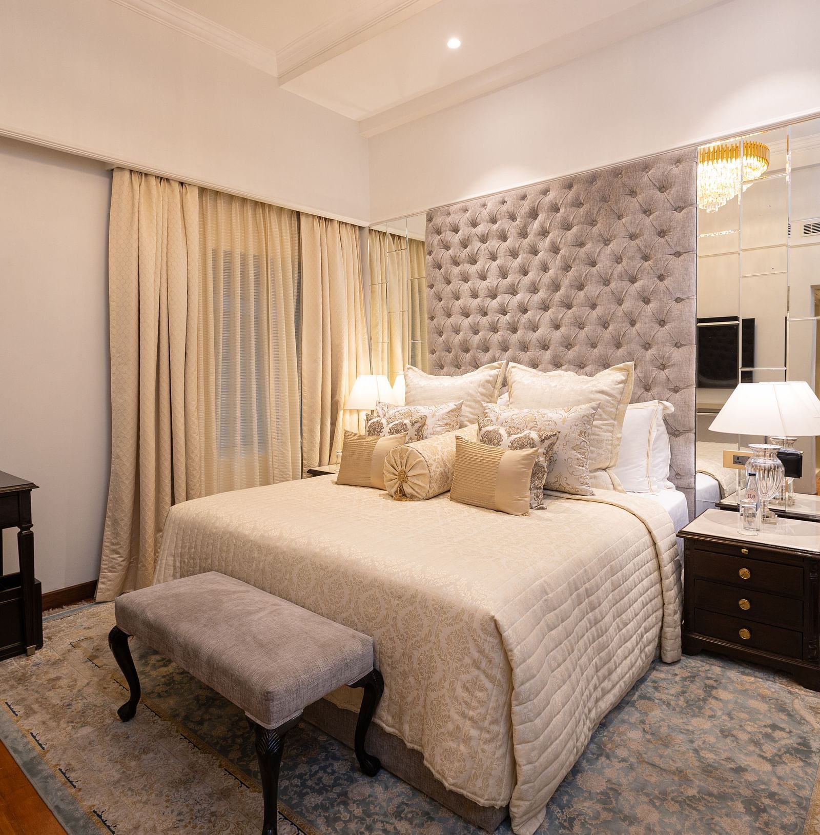 image of the boutique room featuring the king size bed with a small cushioned stool in front of it - The Claridges New Delhi