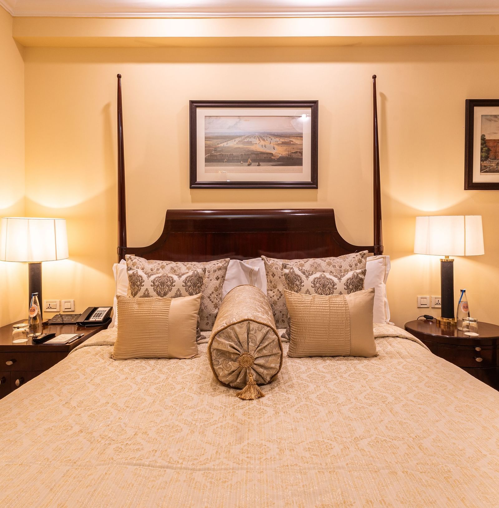 image of a king size bed with table lamps at both sides of the bed at heritage parlour rooms - The Claridges New Delhi
