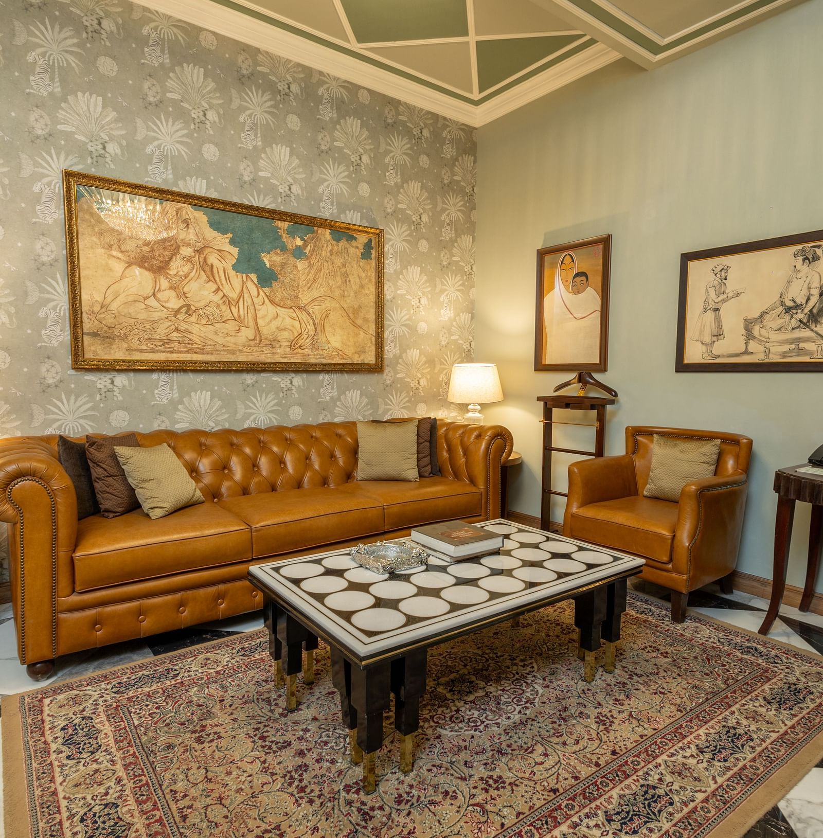 image of the living room at our heritage luxury suite with occur brown couch and a coffee table - The Claridges New Delhi