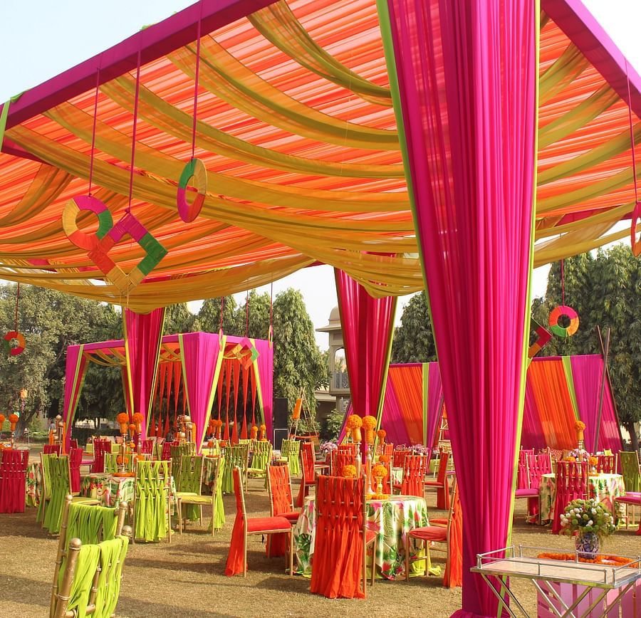a canopy decorated with silk sheets and seats inside the canopy kept for festivities - heritage village resorts & spa, Manesar