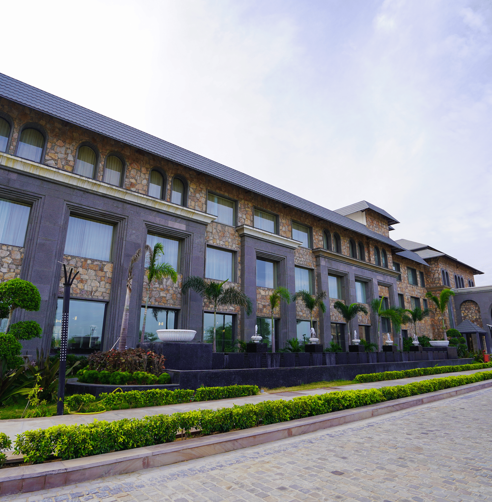 A slightly different perspective of the main resort building, showing the stone and modern glass design.