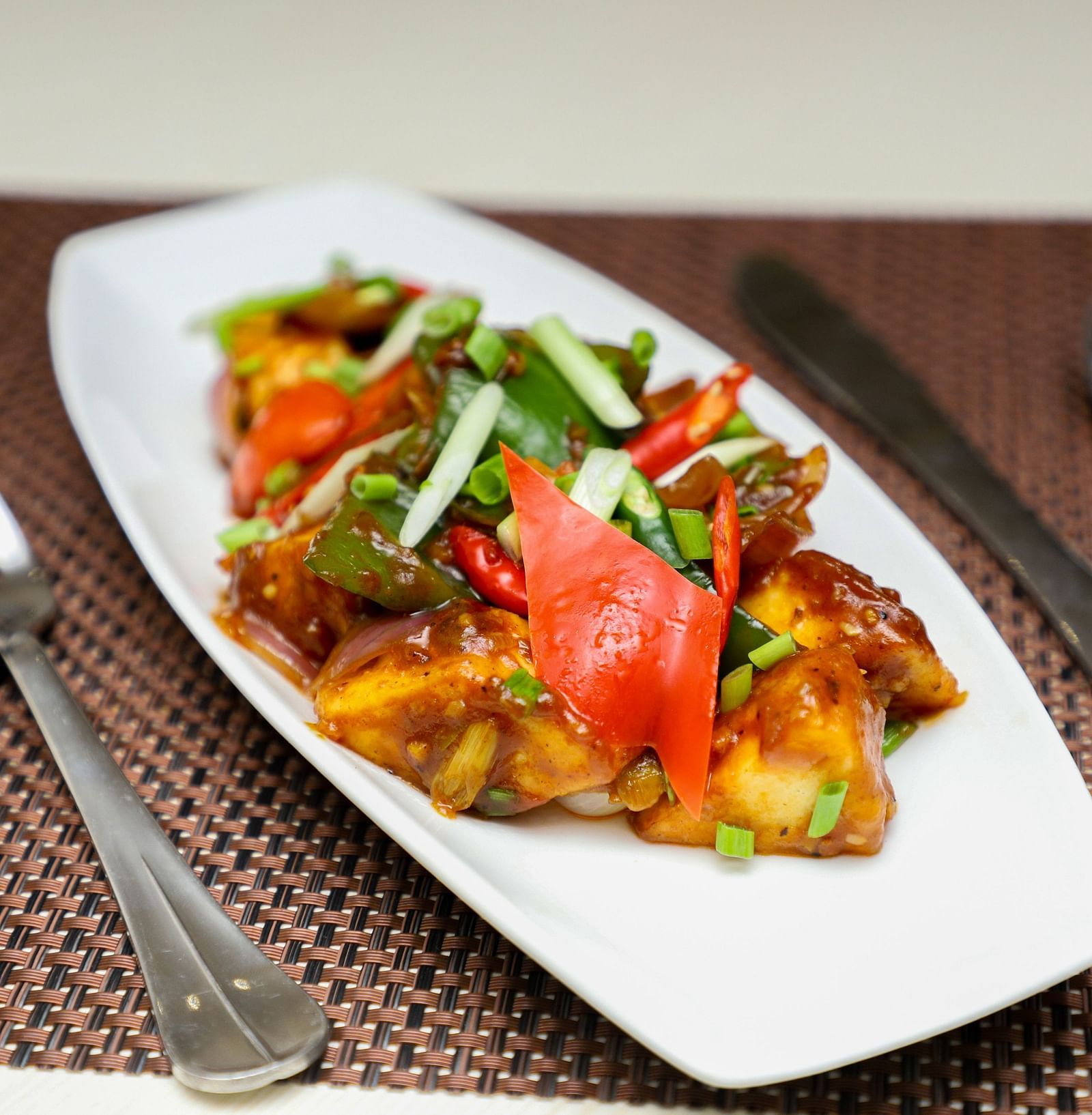 a close up shot of a meal served with cutlery