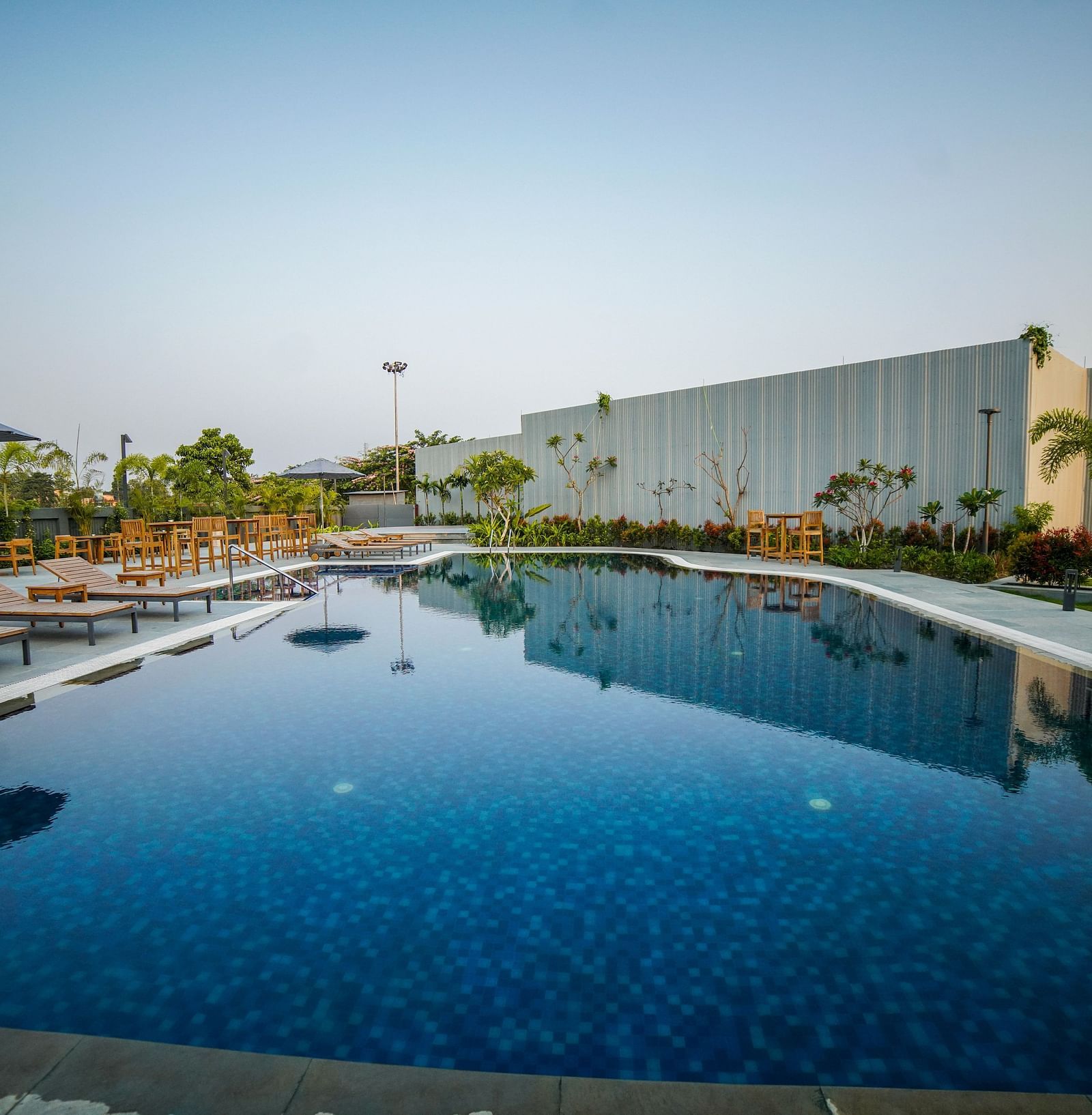The outdoor swimming pool at Singalila Club with lounging chair setup beside it