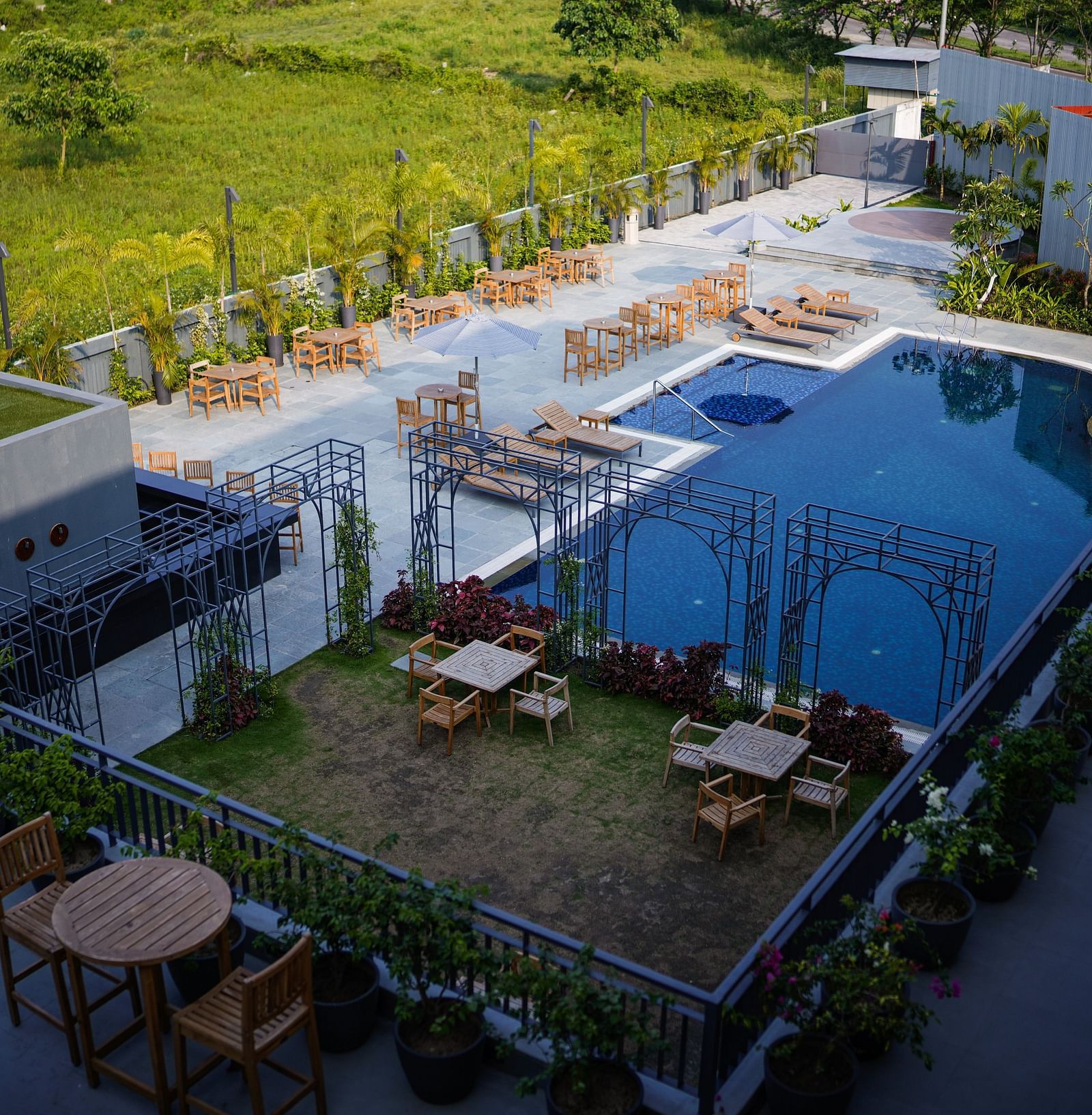 Sub-aerial view of the swimming pool and lounging chair setup at Singalila Club