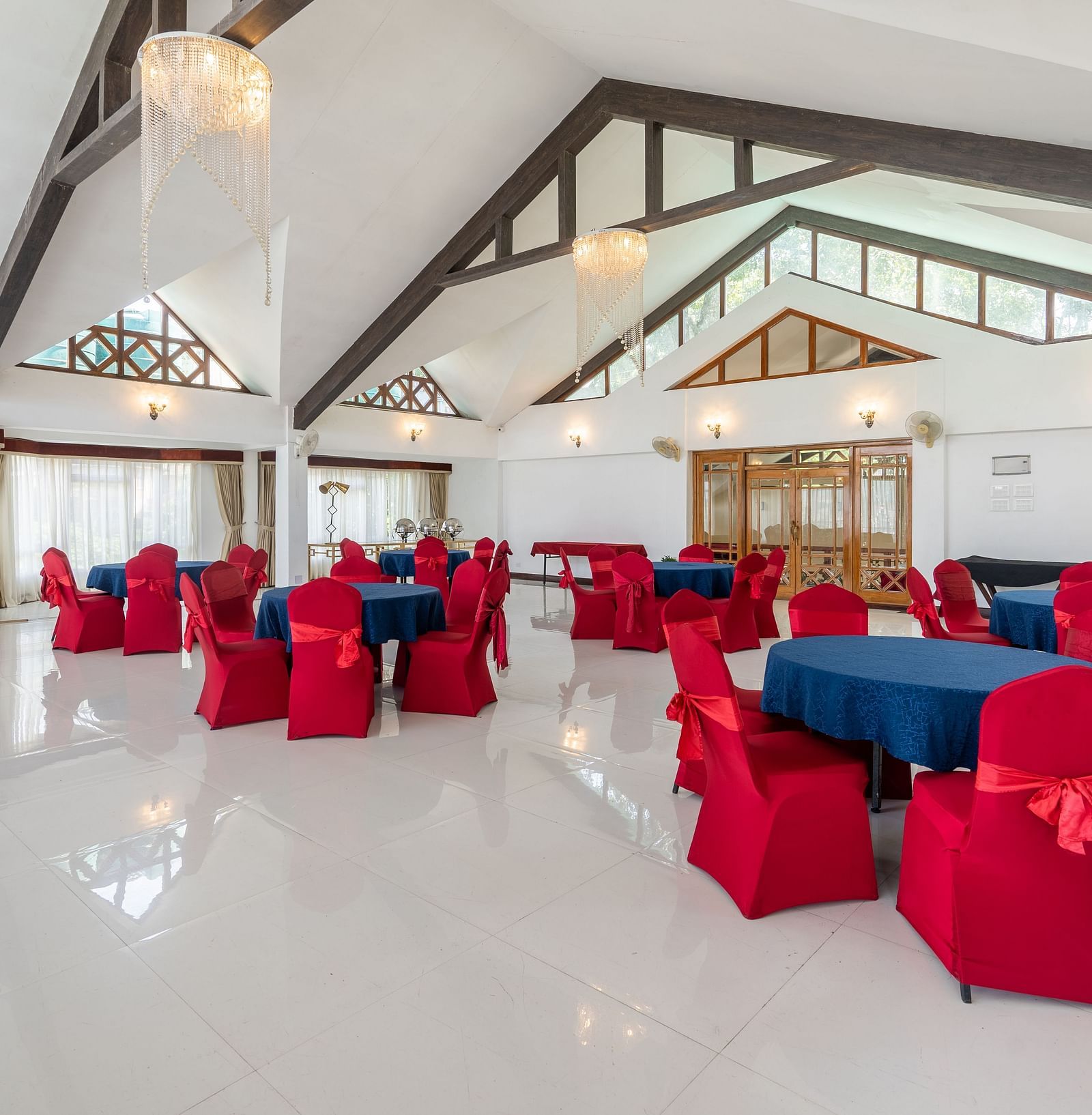event hall with red chairs and blue table at Summit Lillium Hotel & Spa, Kalimpong
