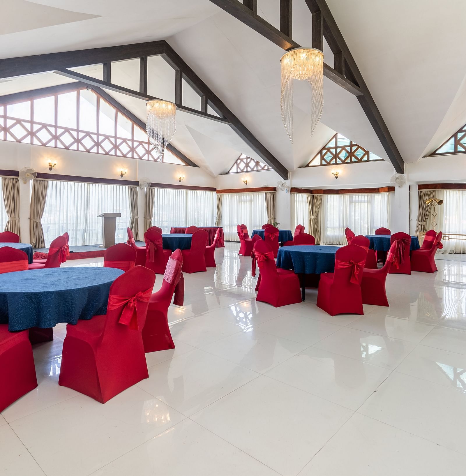 event hall with red chairs and blue table at Summit Lillium Hotel & Spa, Kalimpong