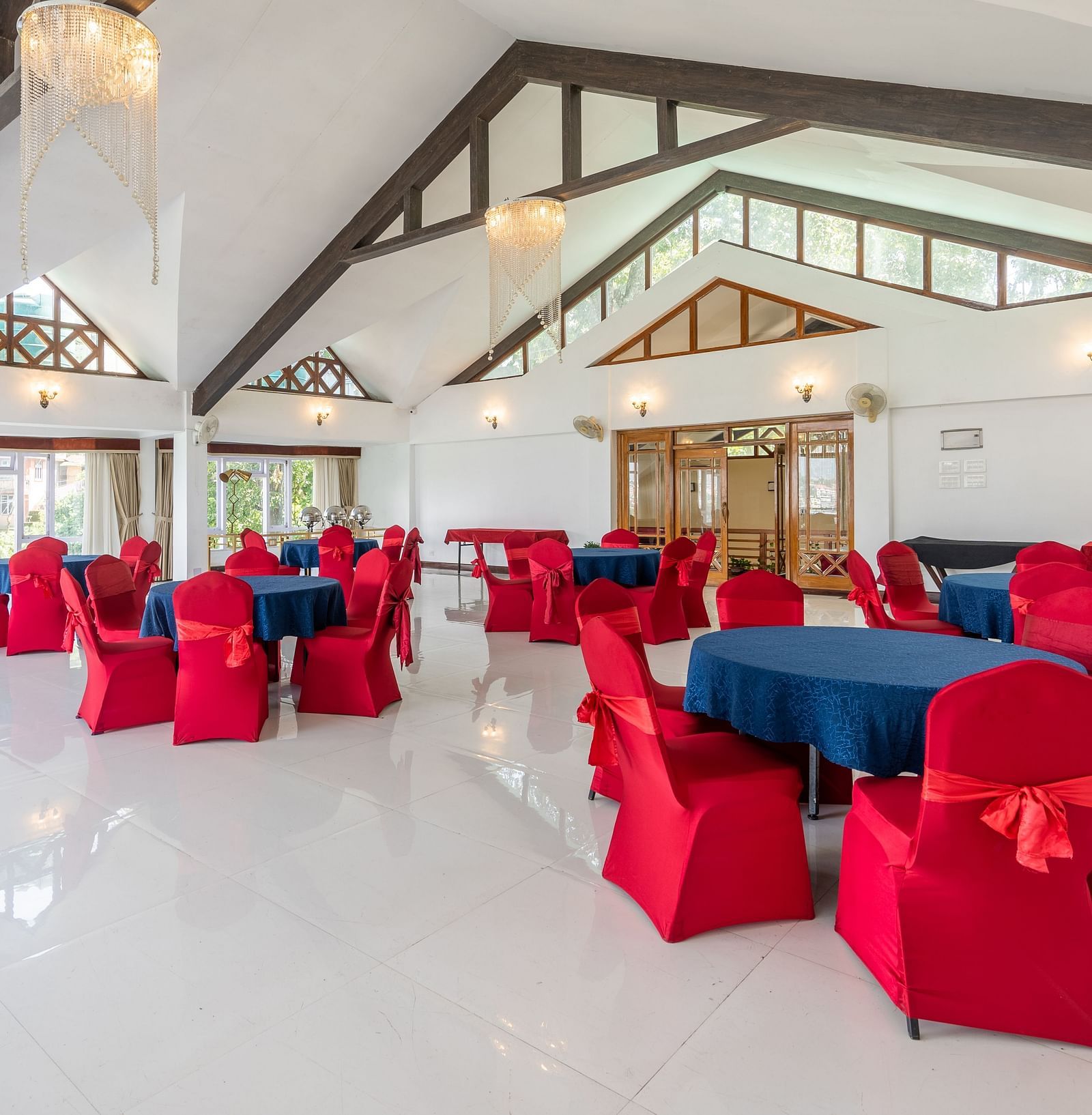event hall with red chairs and blue table at Summit Lillium Hotel & Spa, Kalimpong