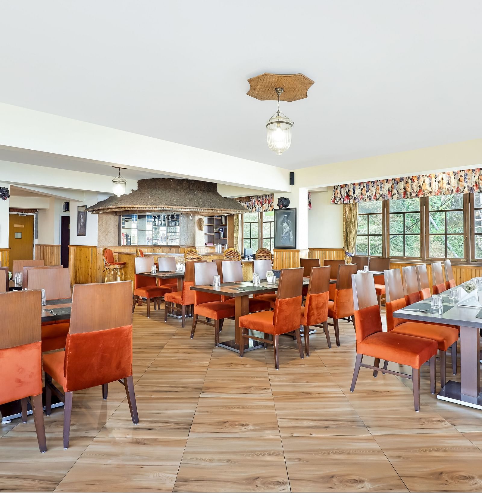 A full view of multiple dining tables and chairs placed in a closed hall | Summit Newa Regency & Spa, Pelling
