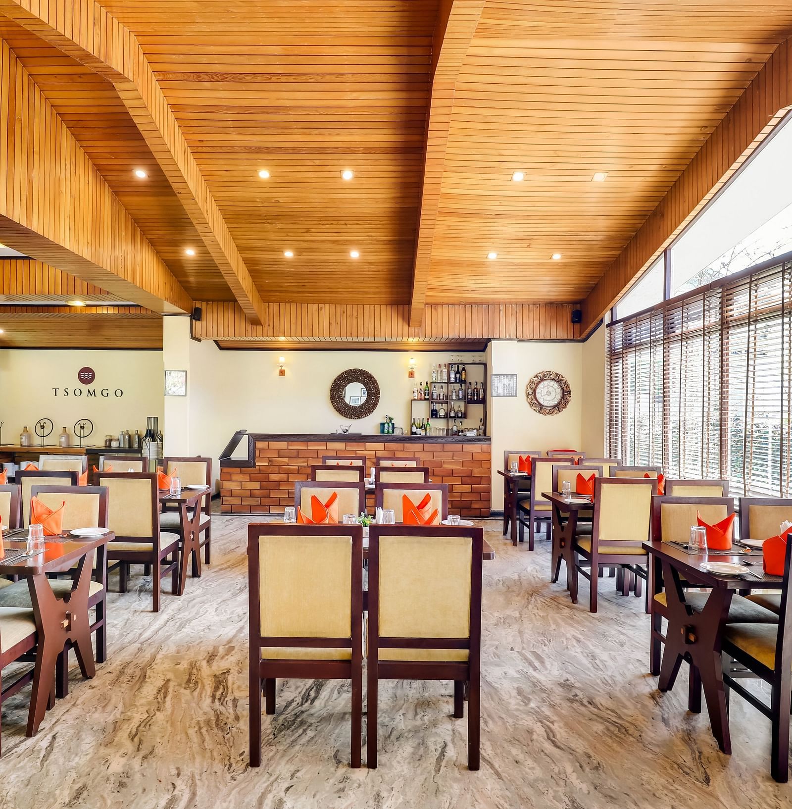 Tsomgo restaurant features cozy lighting, wooden tables and chairs, and culinary arrangements meticulously presented at Summit Norling Resort & Spa, Gangtok2