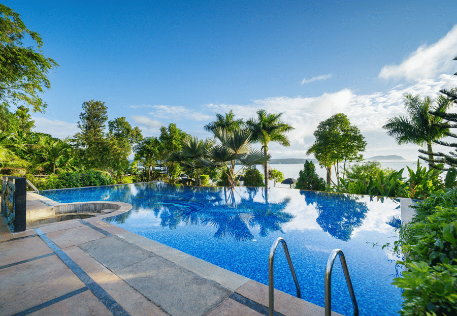 Image of a swimming pool with trees surrounding it at Coorg Jungle Camp Backwater Resort, Kushalnagar.