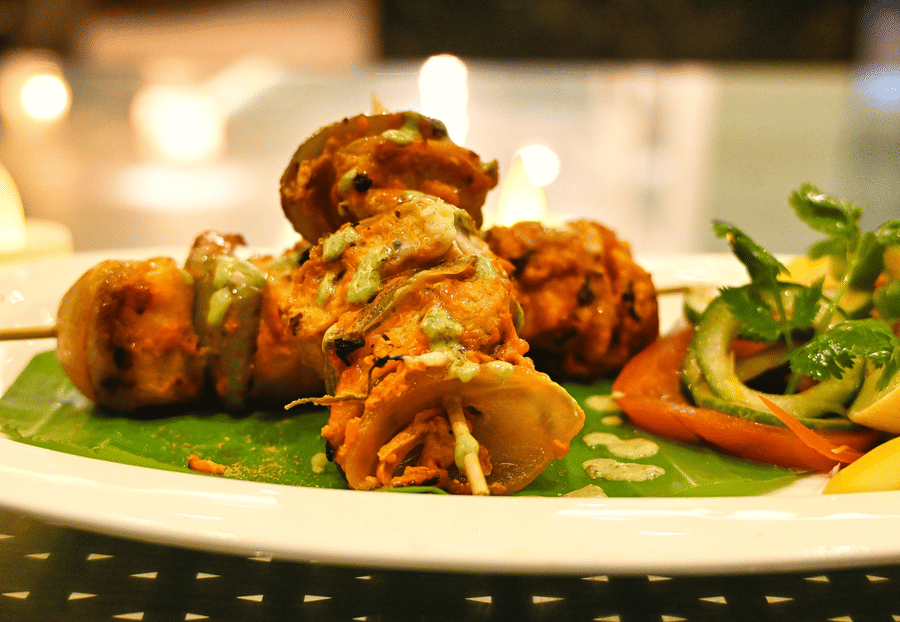 Image of a plate filled with food on skewers at Coorg Jungle Camp Backwater Resort, Kushalnagar.