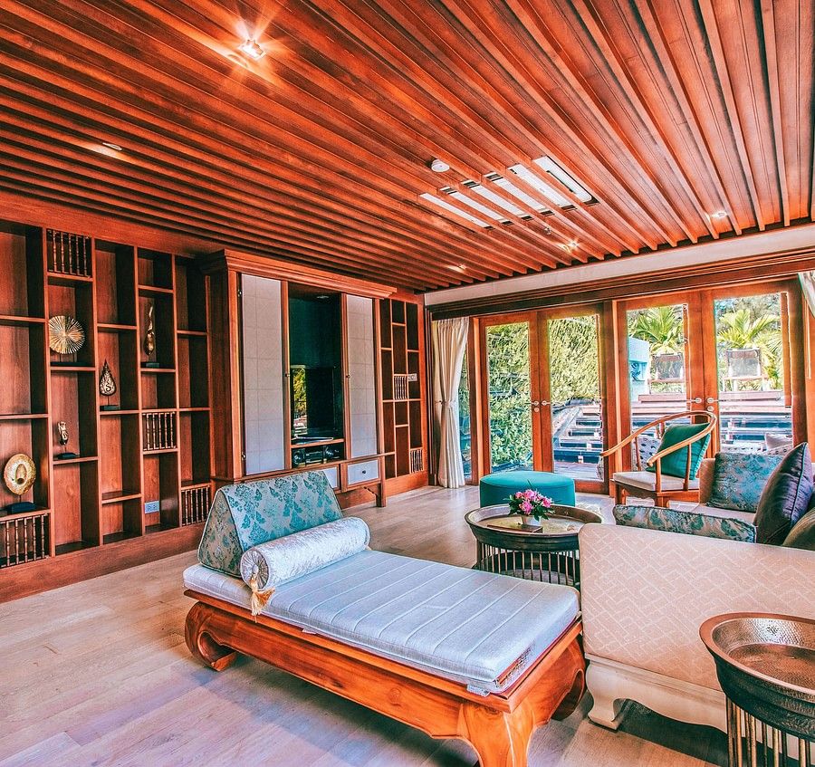 alt-text corner view image of the living area featuring a beautiful compartmentalised wall with modern artefacts - three bedroom private pool villa