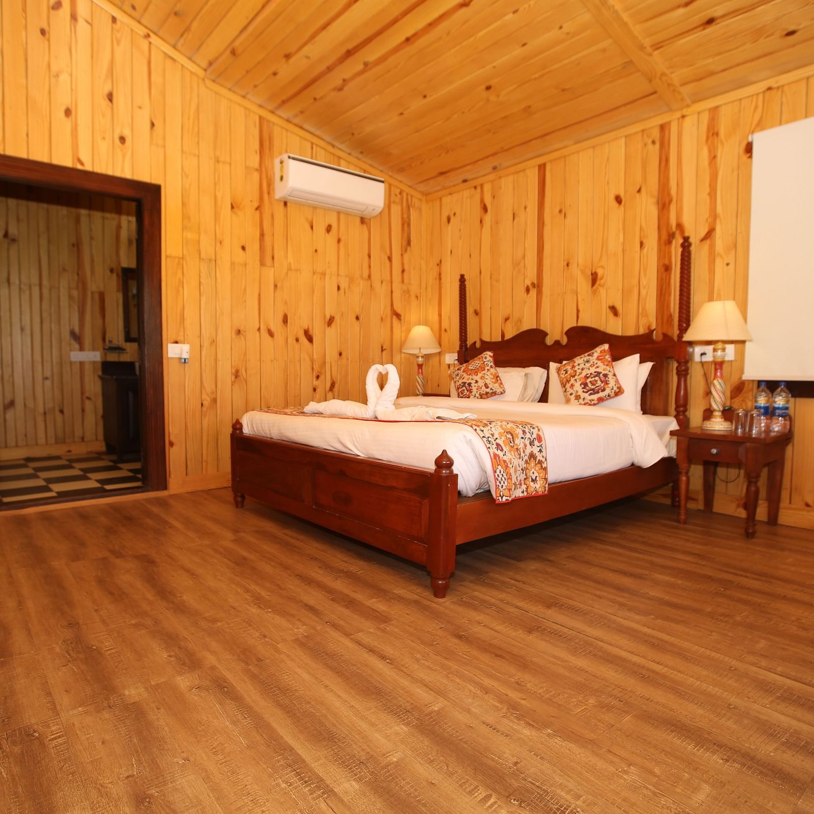 Spacious Kashmir Cottage Villa's Pool room with a king-sized bed, wooden flooring at Aanandam Resort & Spa