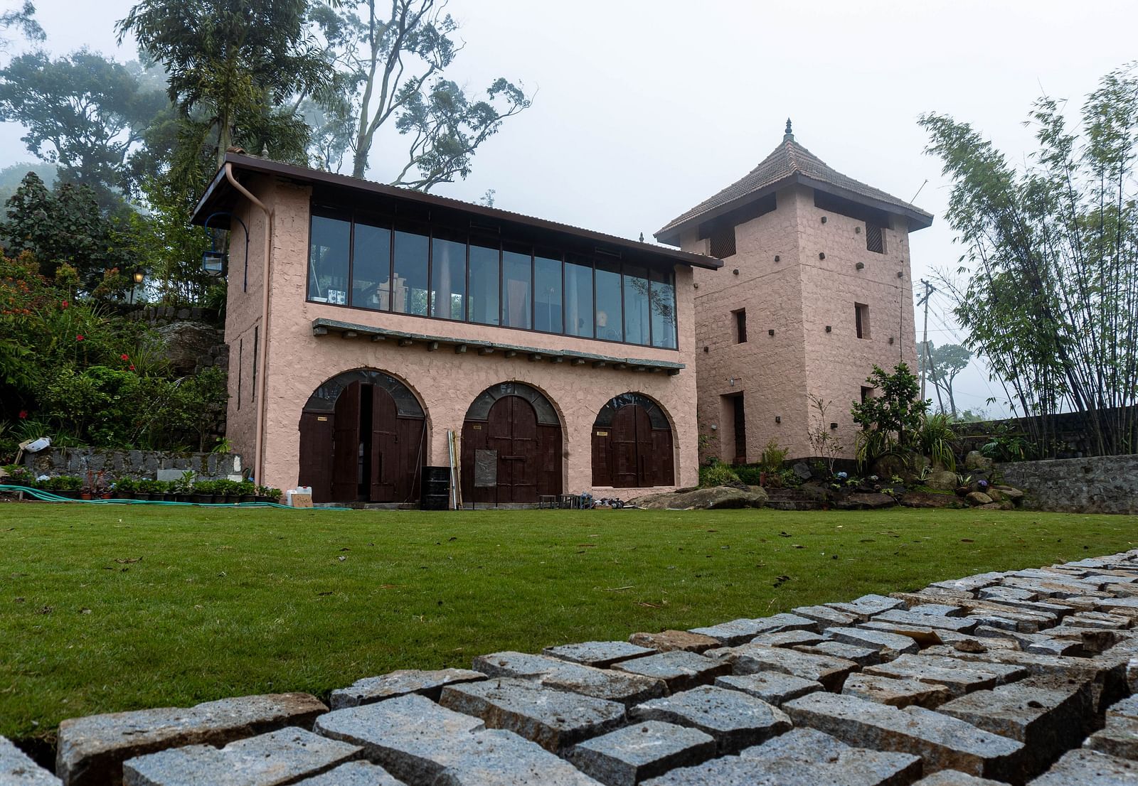 Low angle view of the resort with a path to walk and foliage in front the building  | Mango Hill, Yercaud