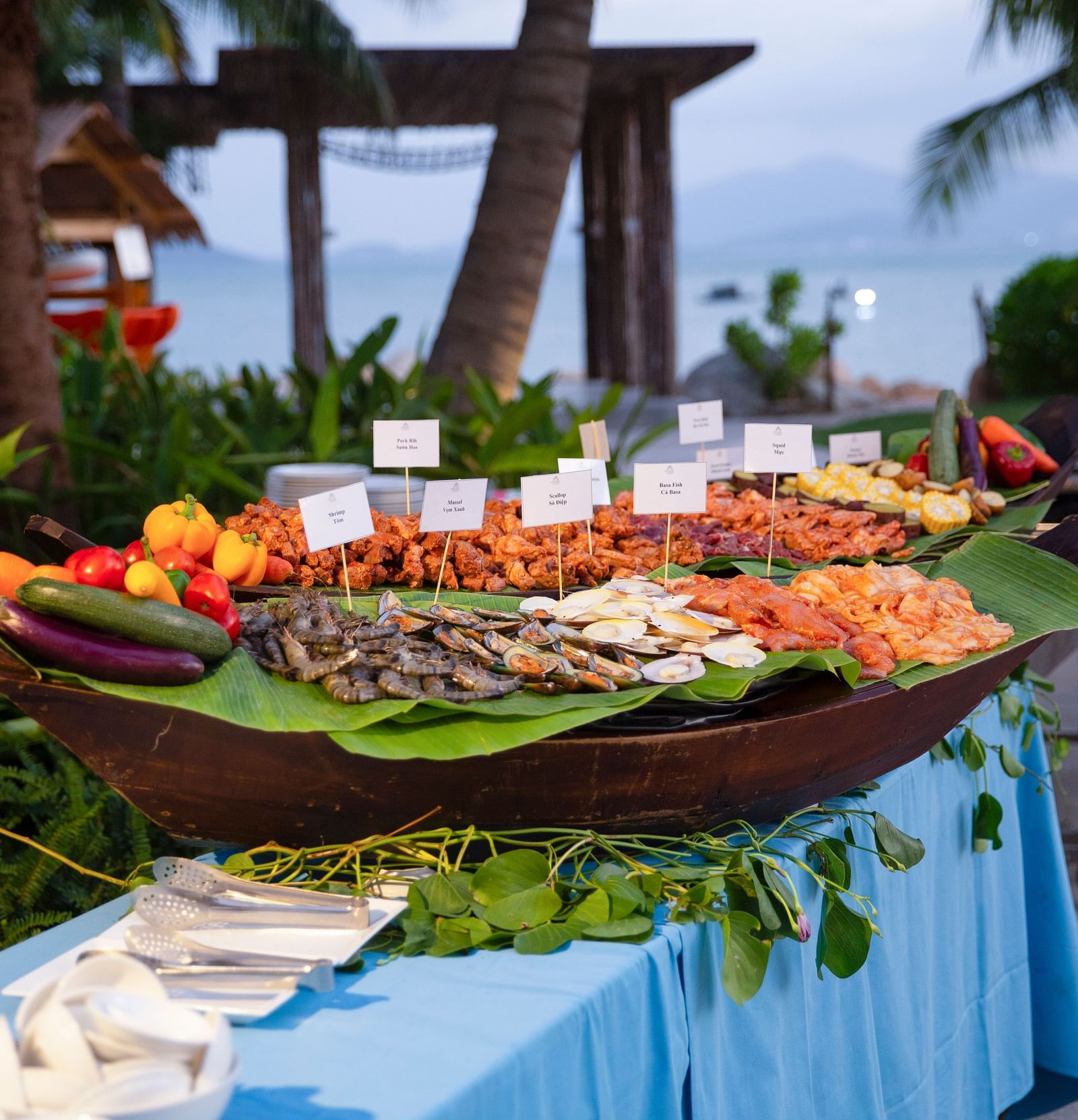 An image of a bucket where different kind of seafood are placed - Alibu Resort Nha Thrang