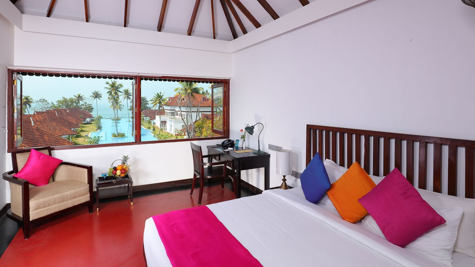 an image of a Lake View Terrace Suite with a comfortable bed , a working desk and a sofa with a swimming pool view from the room - at Rhythm Kumarakom